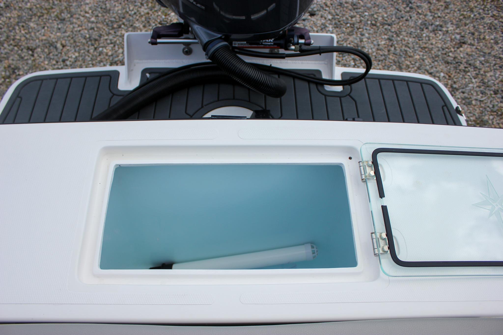Livewell compartment on a 2022 NorthCoast 235 Cabin boat, featuring a sleek design.