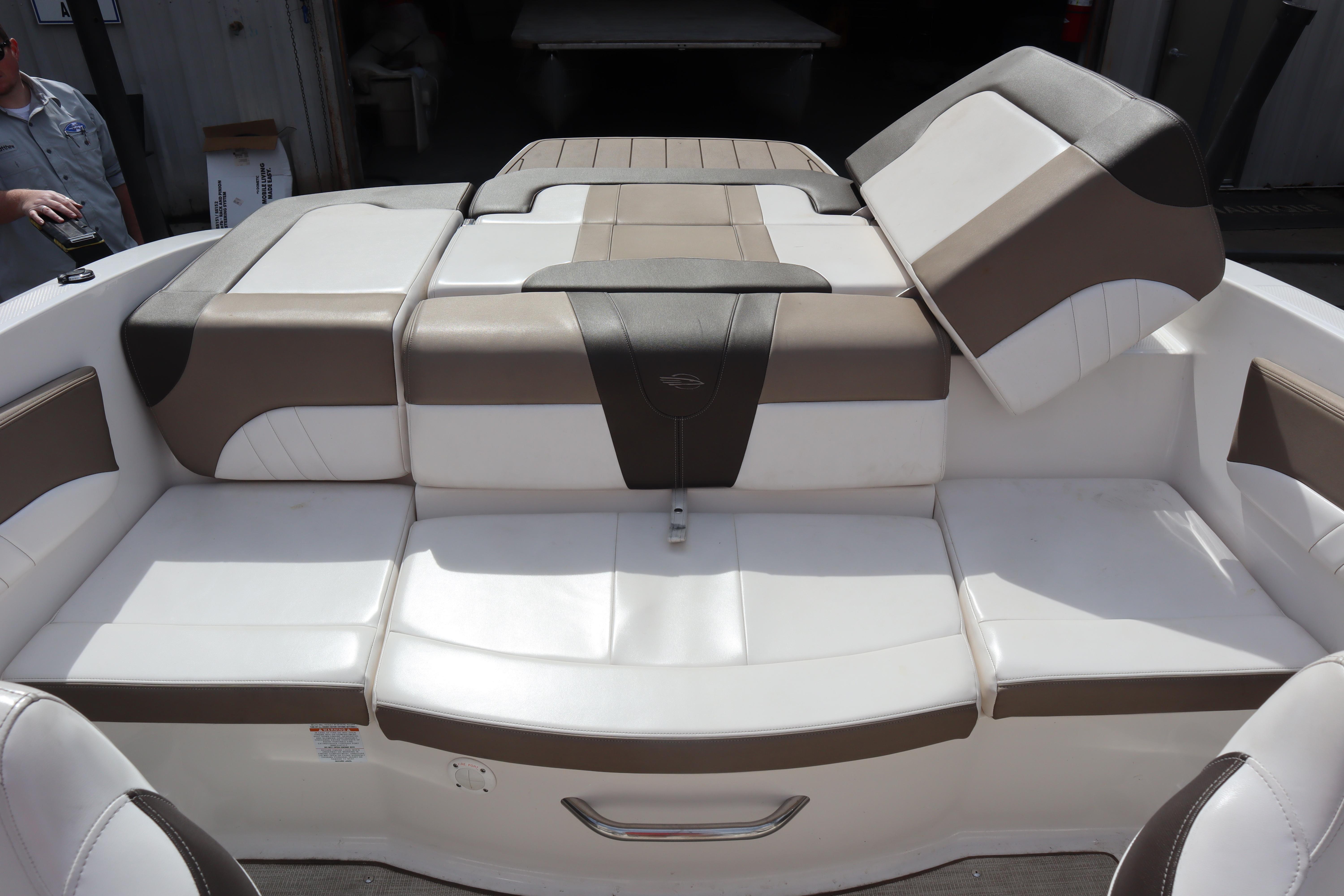2021 Chaparral 21 SSi boat interior with white and brown cushioned seating.