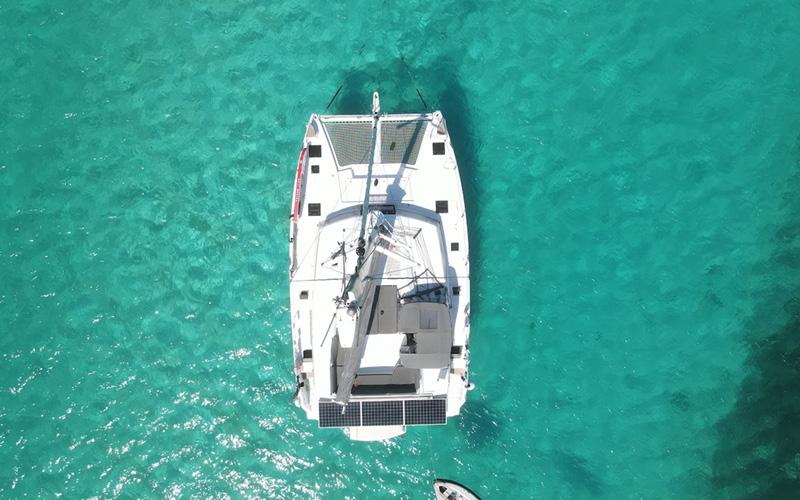 Aerial view of 2022 Fountaine Pajot Elba 45 catamaran on turquoise water.