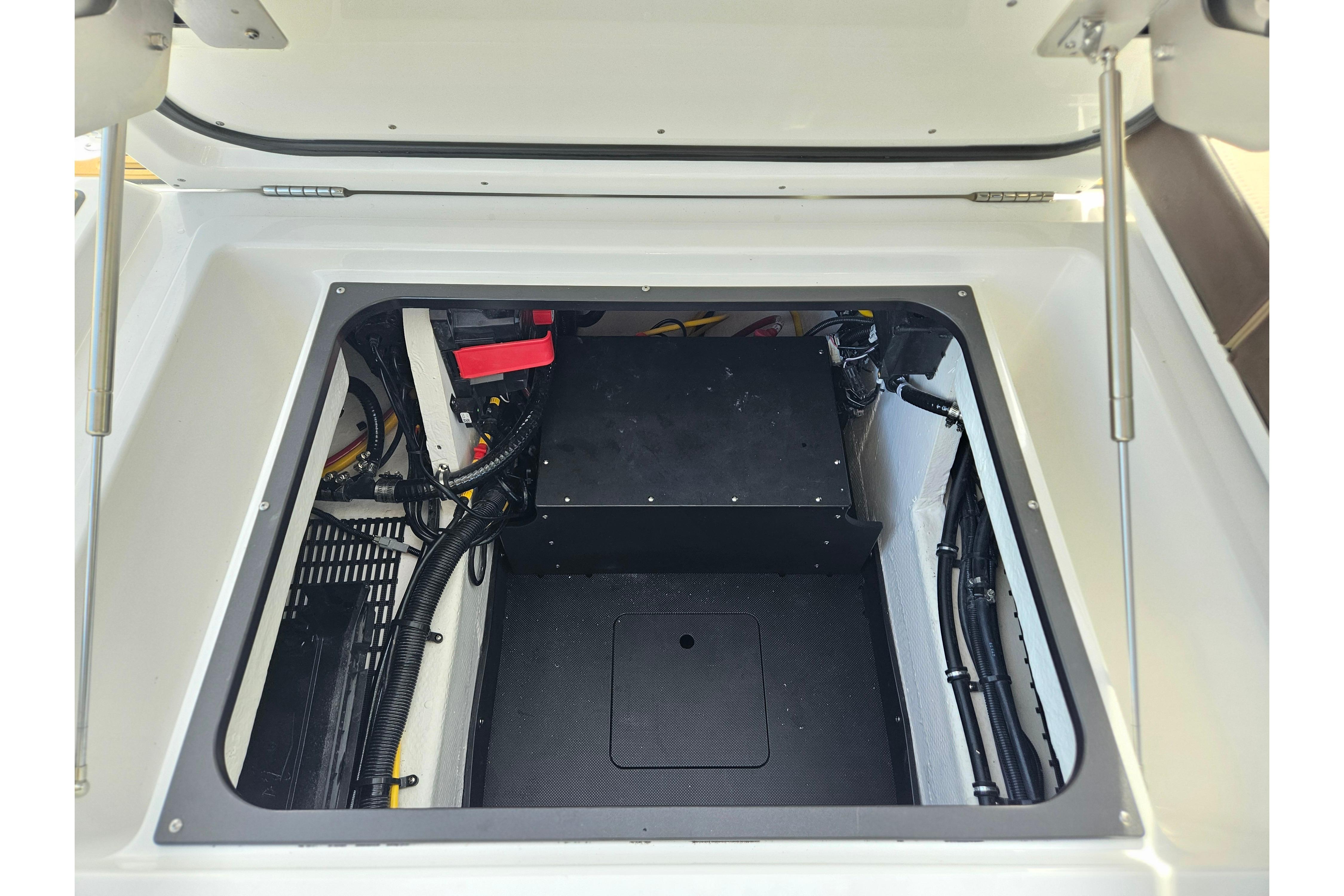 Engine compartment of 2026 Monterey Elite 27 OB boat, showcasing wiring and components.