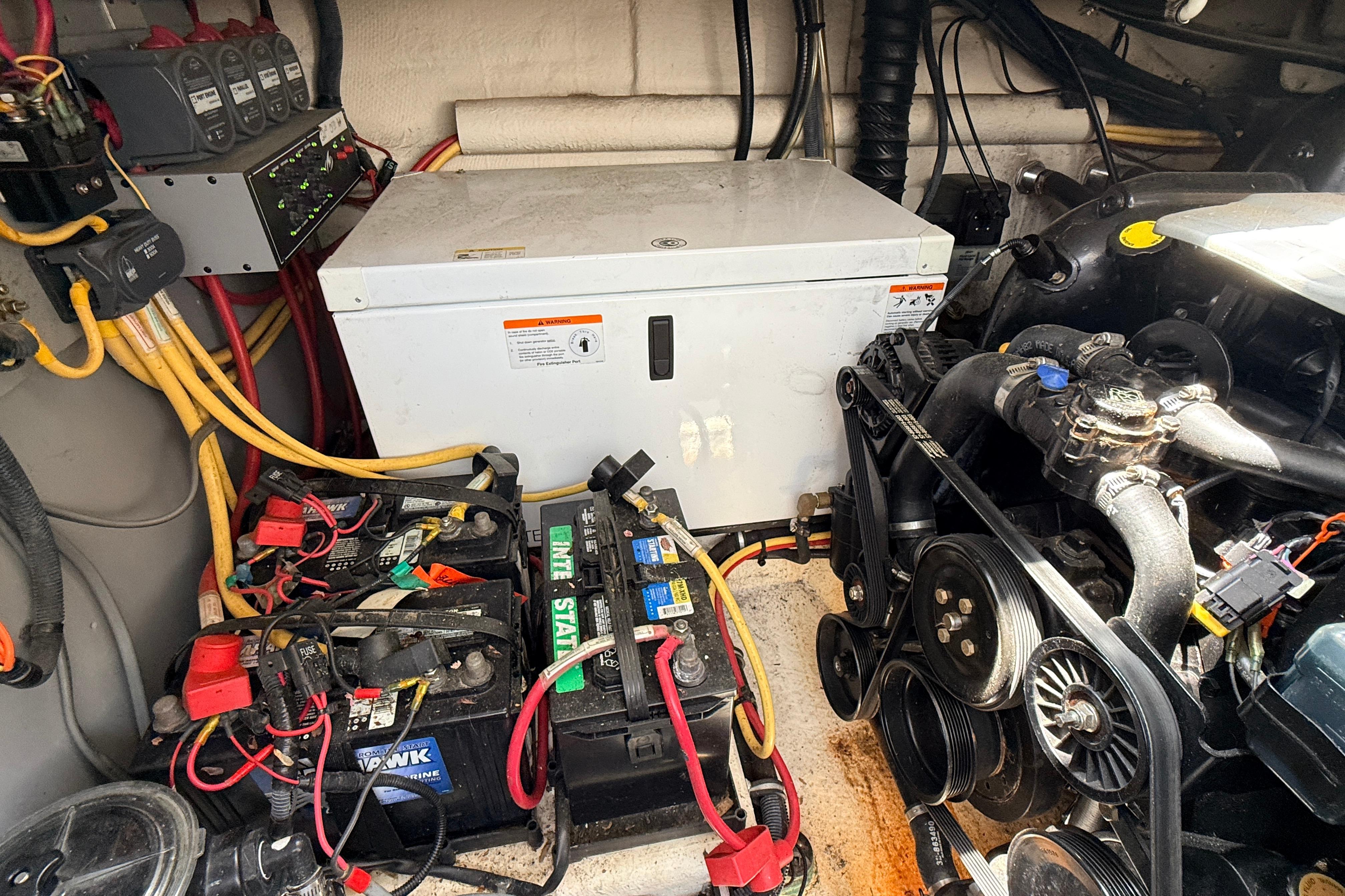 Engine compartment of a 2011 Monterey 320 Sport Yacht with batteries and wiring.