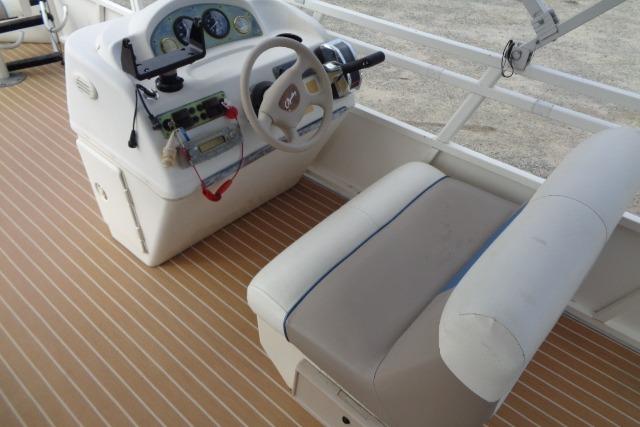 2008 Bentley Pontoons 200 CRUISE helm with steering wheel and controls on a wooden deck.
