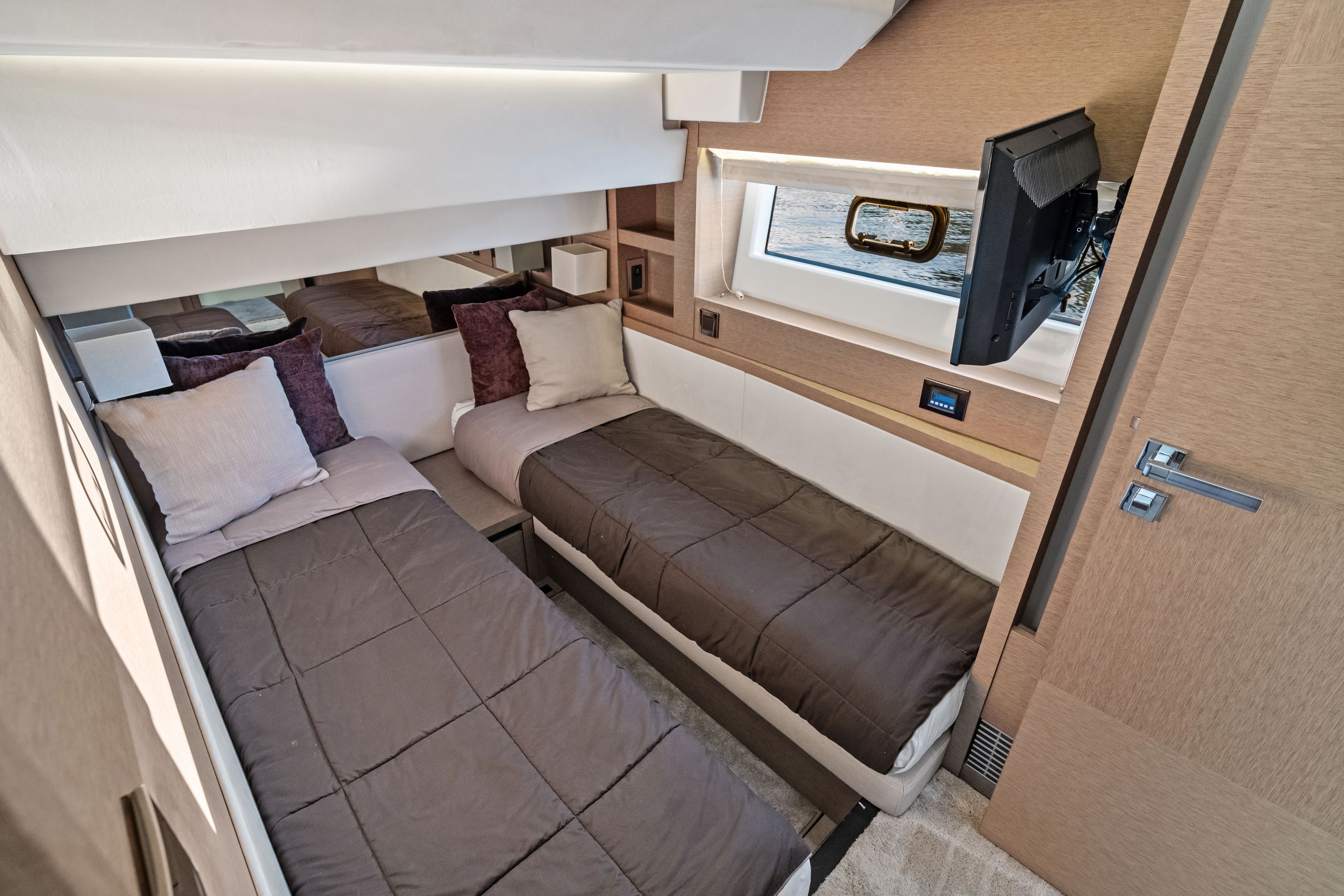 Interior of a 2018 Prestige 630 yacht with twin beds.