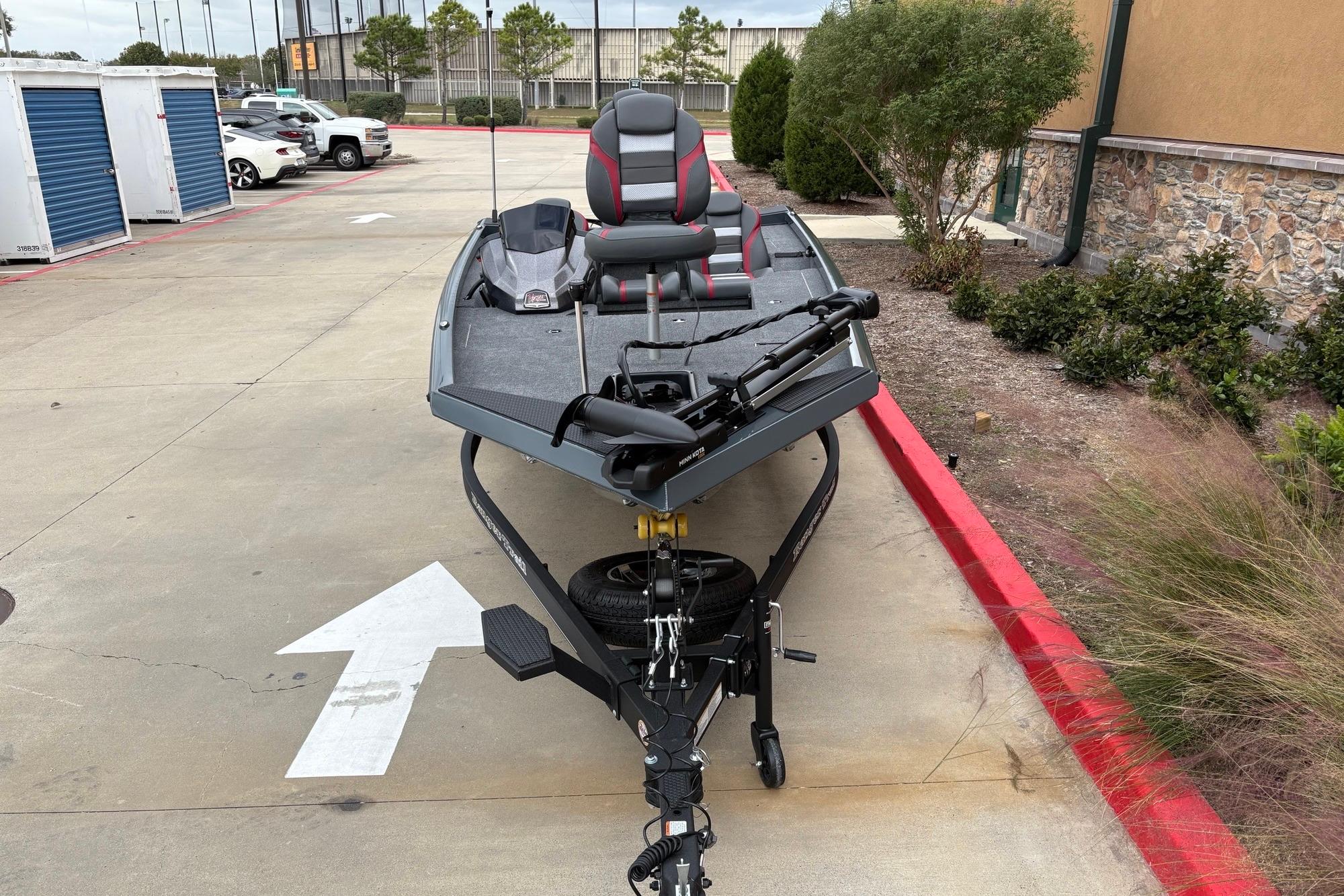 2026 Ranger RT178 boat on trailer in parking lot, featuring sleek design and modern seating.