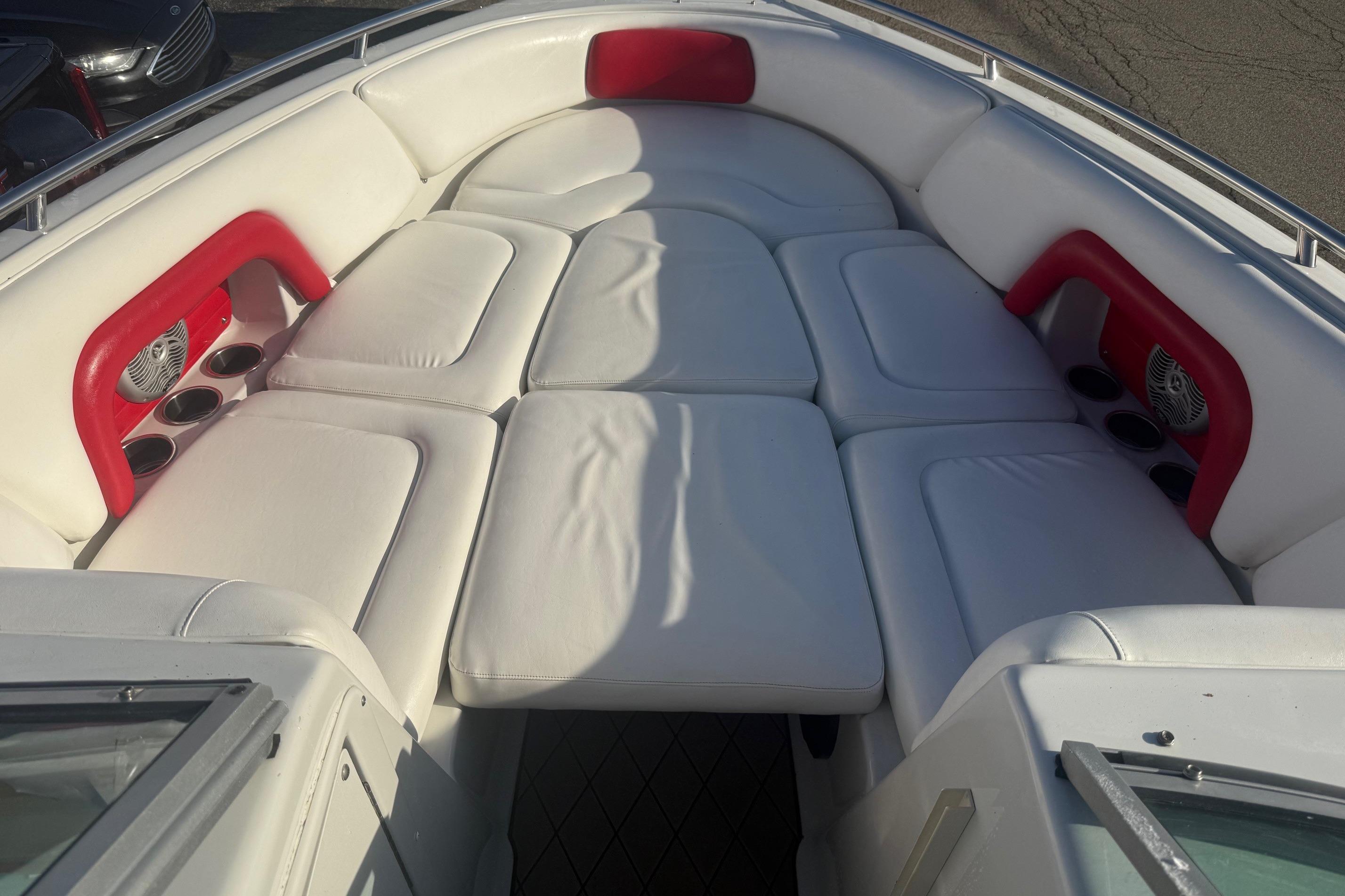 2005 Crownline 270 BR boat interior with white cushioned seating and red accents.