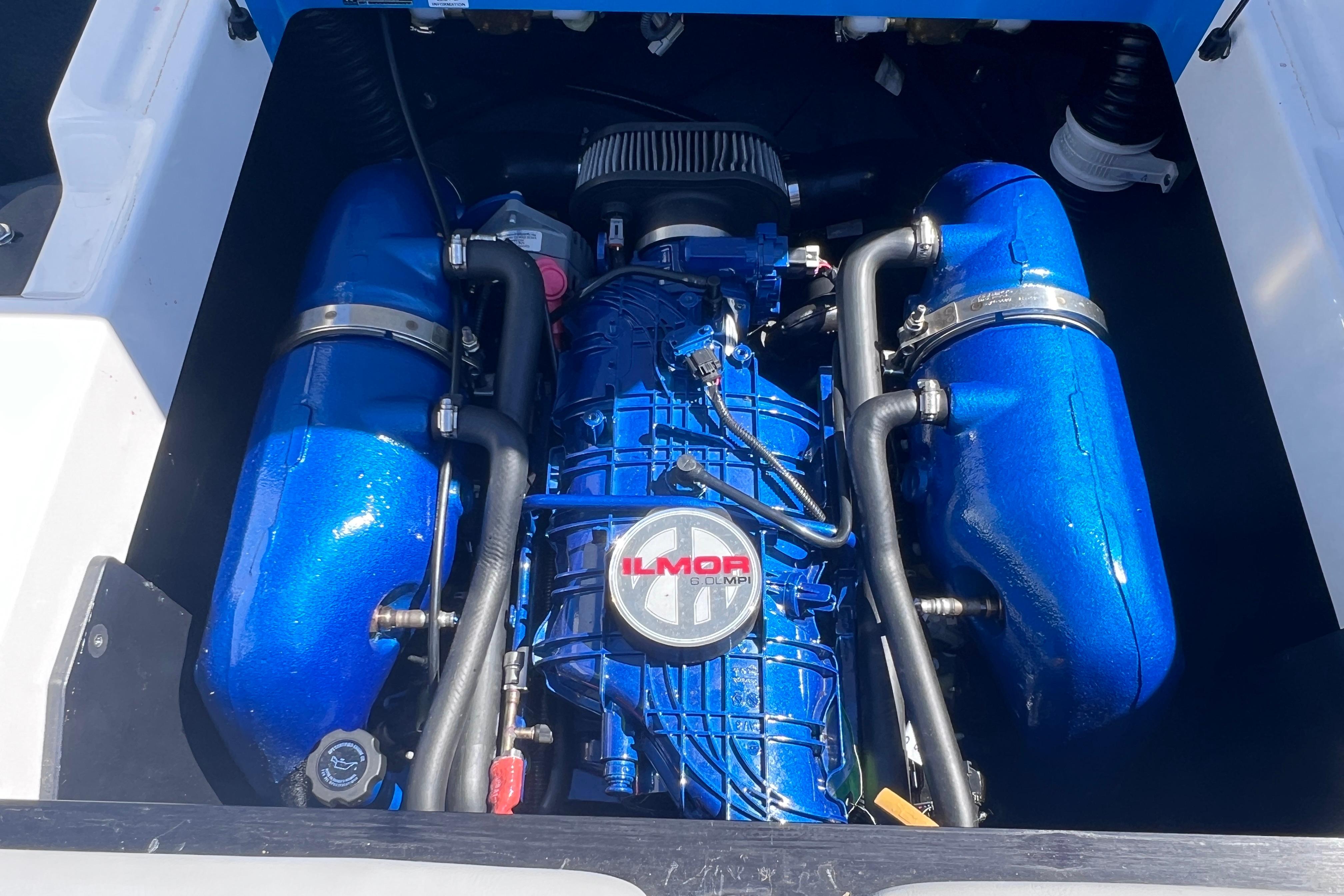 2021 MasterCraft XT23 engine with blue Ilmor components, showcasing powerful marine performance.