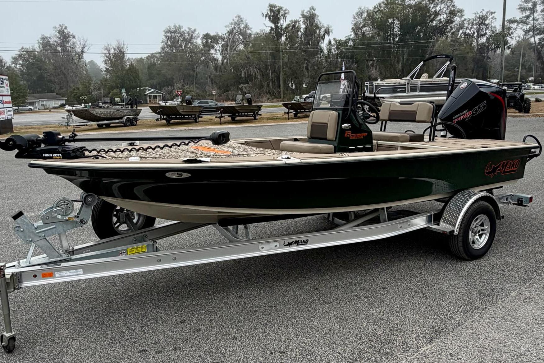 2025 Mako 18 Pro Skiff Backwater Edition boat on trailer, parked outdoors.