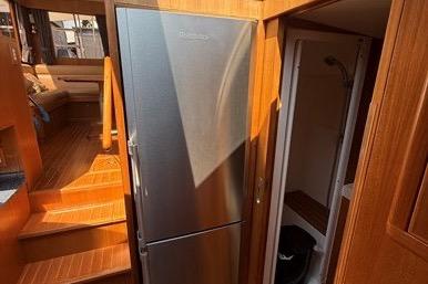2007 Island Pilot 395 interior with stainless steel fridge and wooden finishes.