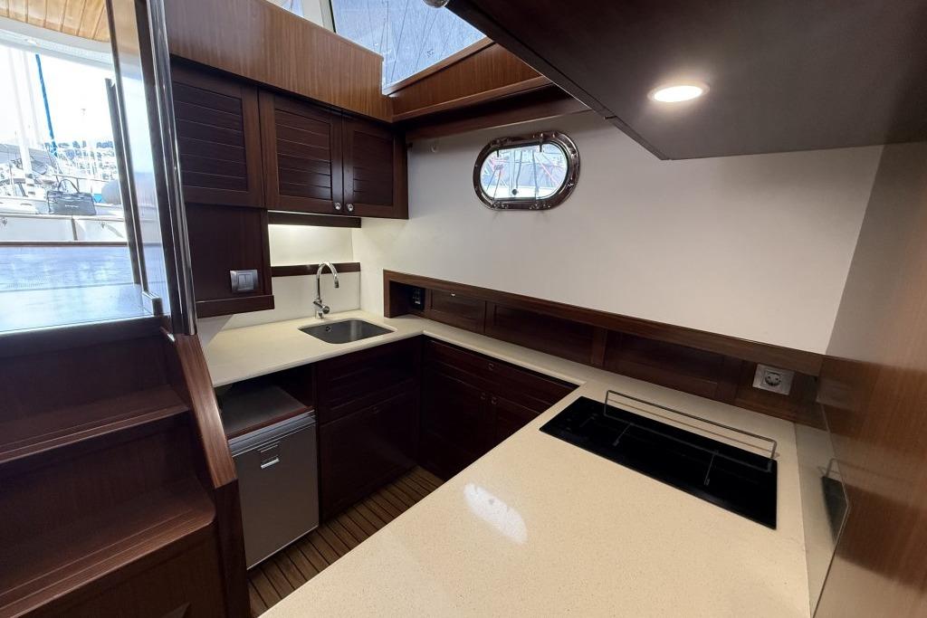Luxurious 2012 Sasga Yachts Menorquin 42 kitchen with modern appliances and elegant wood finish.