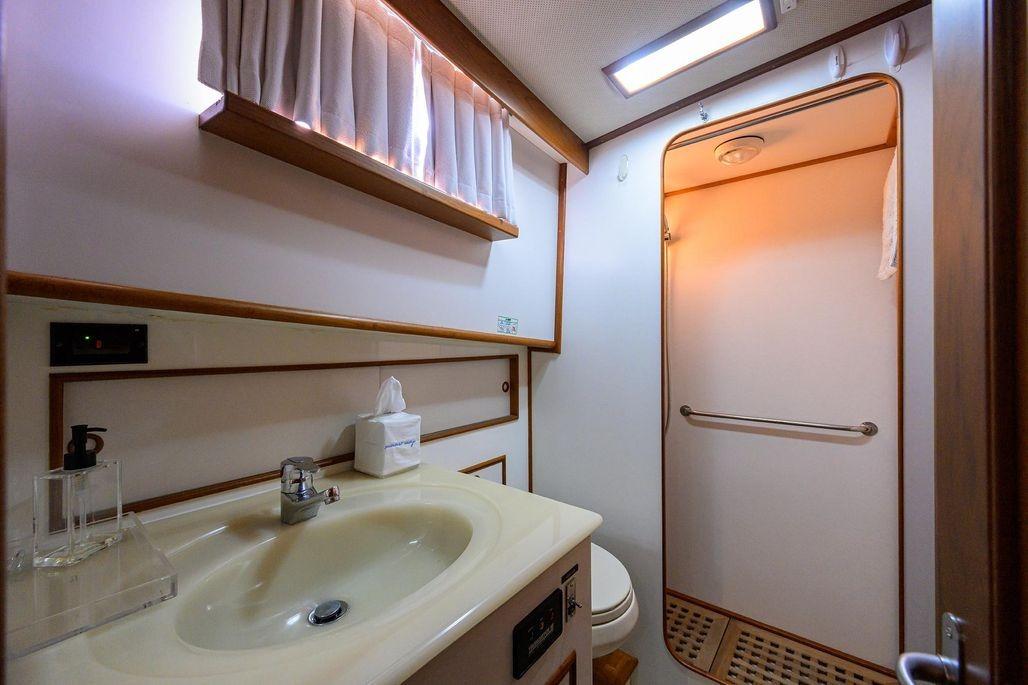 Bathroom interior of 1999 Grand Banks 42 Europa yacht, featuring sink and shower area.