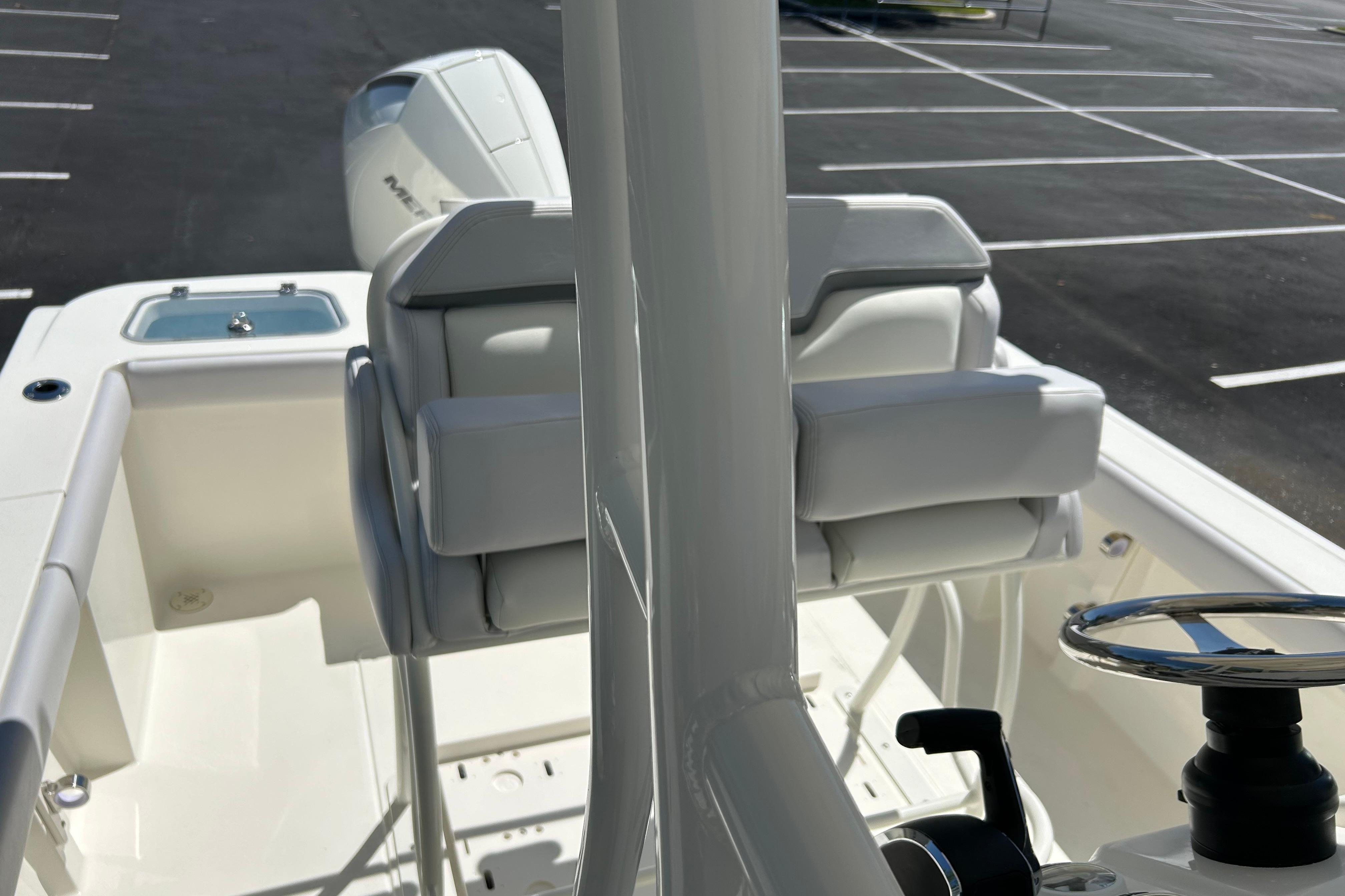 2026 Mako 226 Center Console boat interior with steering wheel and seating.