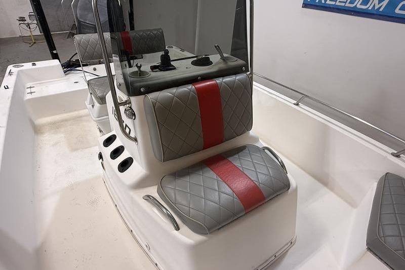 1996 Century 1800 Center Console boat interior with gray and red cushioned seats.