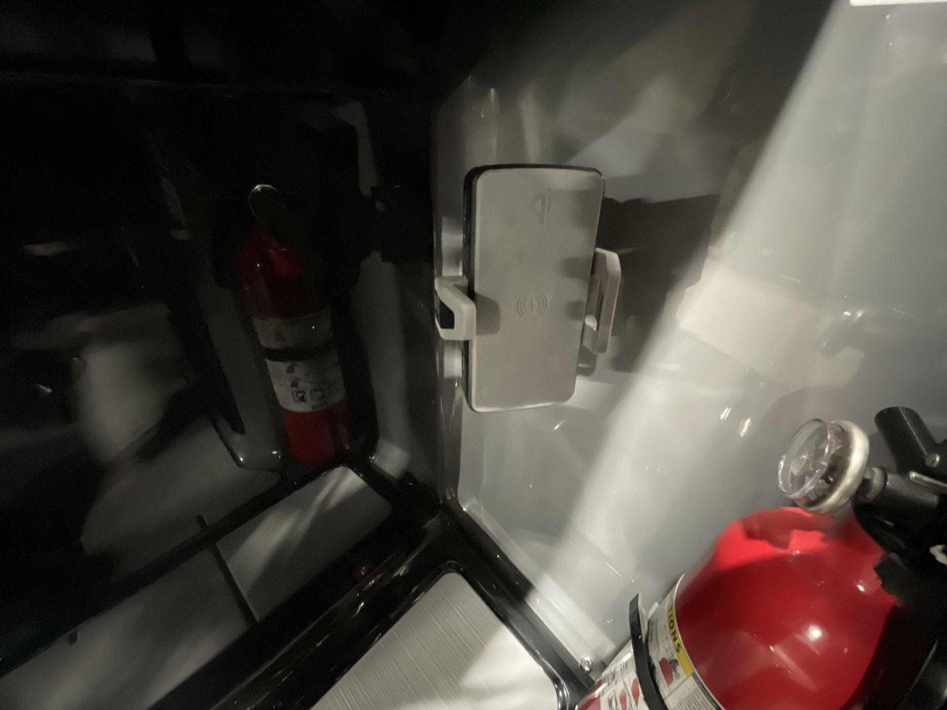 Fire extinguisher inside Balise Horizon 26C vehicle, 2025 model, with interior lighting.