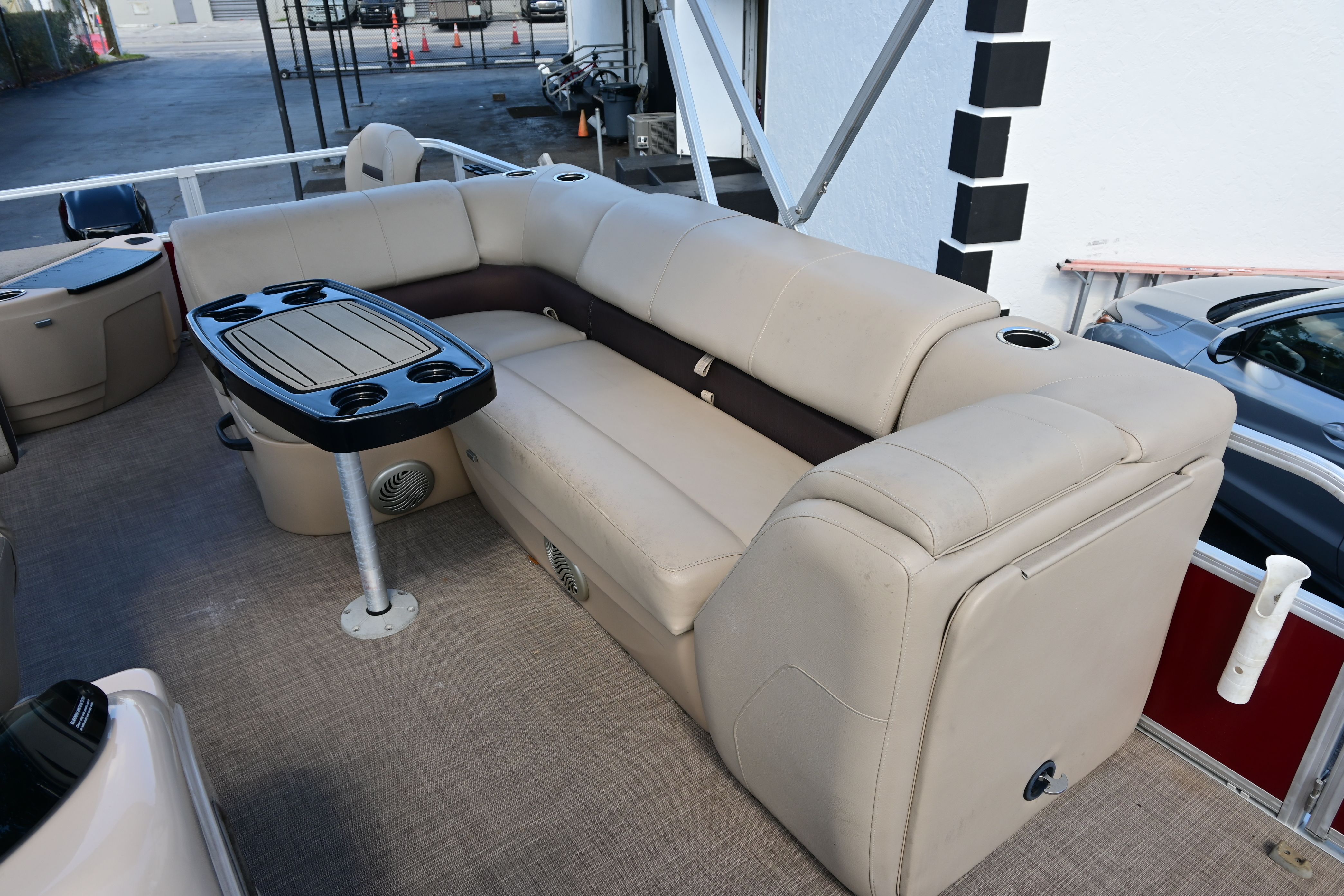 2019 Sun Tracker FISHI pontoon boat with beige sofa and table.