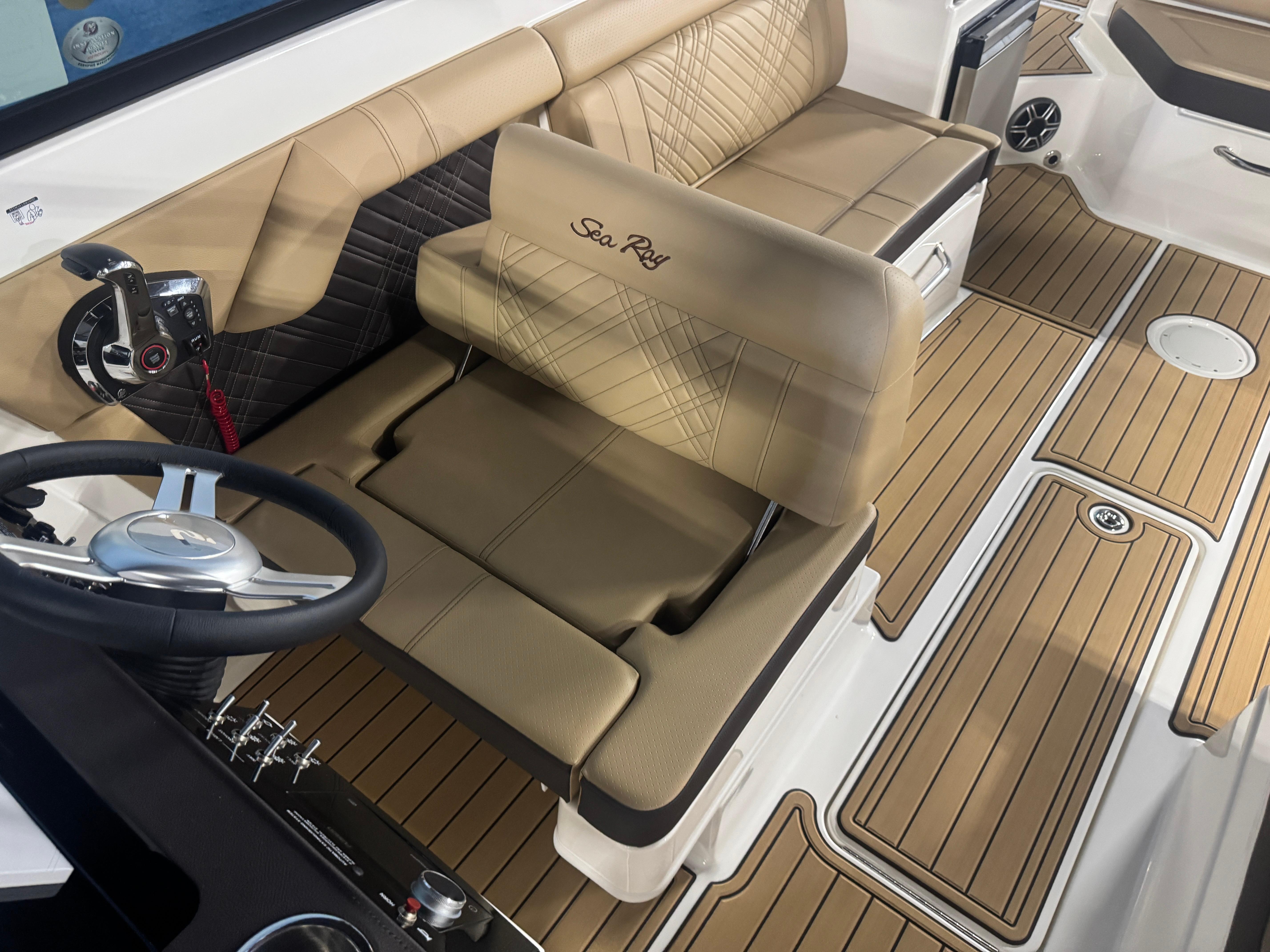 2026 Sea Ray SDX 290 boat interior with tan seating and modern steering wheel.