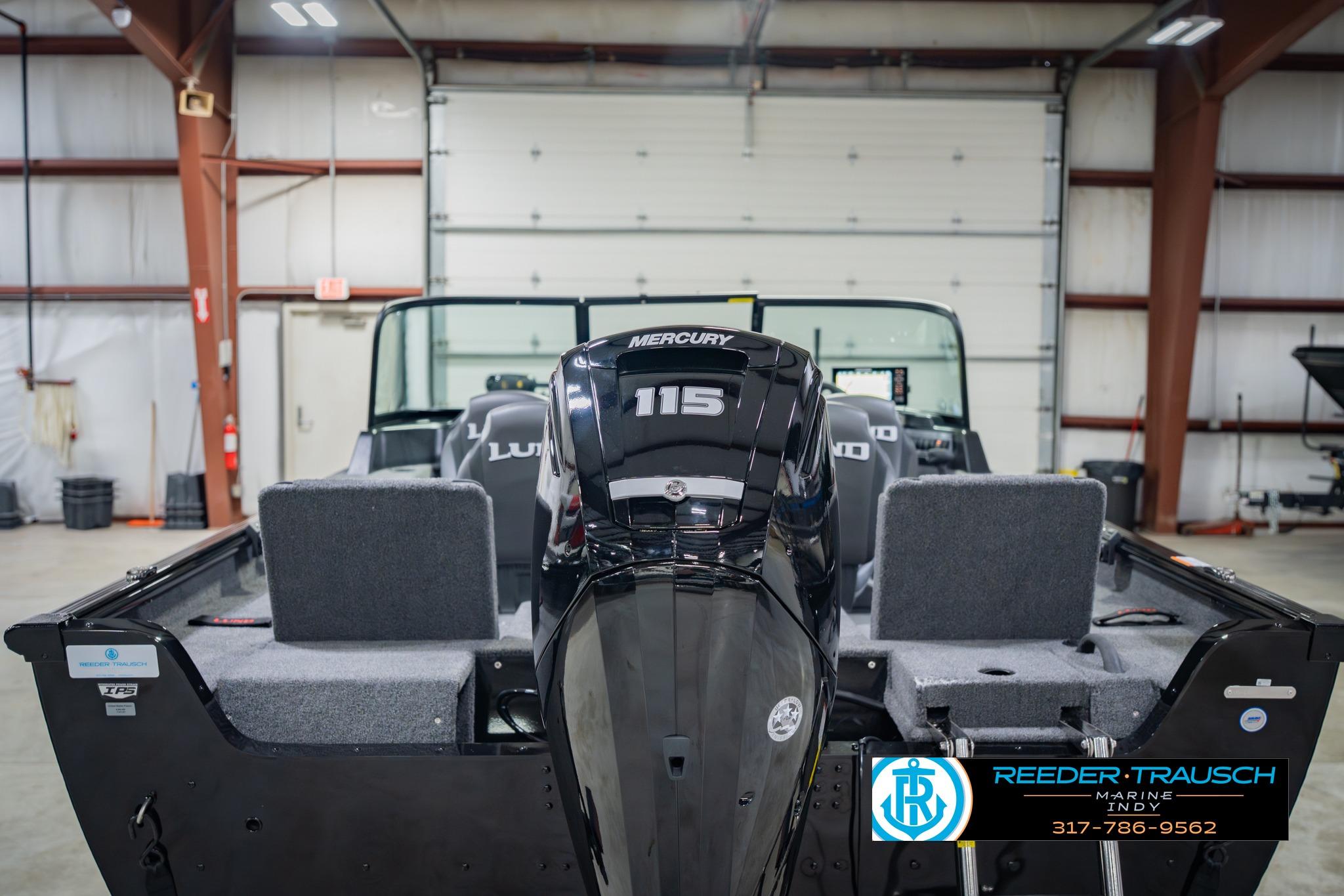 2026 Lund 1775 Impact XS boat with Mercury 115 engine in a garage setting.