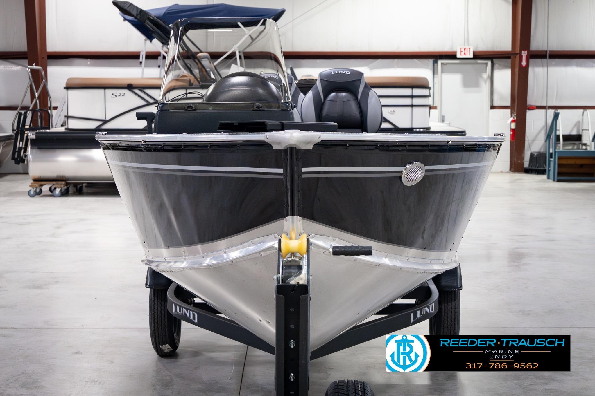 2026 Lund 1600 Fury SS boat in showroom, front view with trailer.