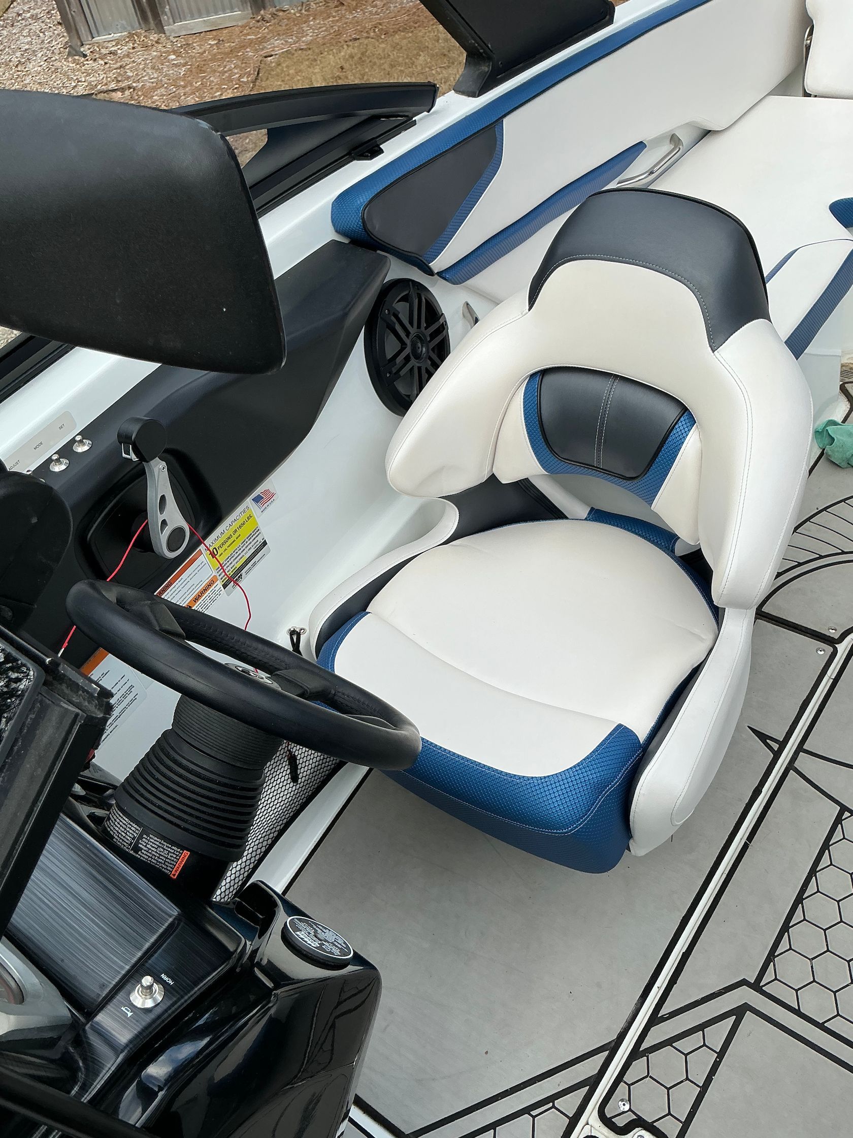 Interior of a 2021 Scarab 215 ID boat with blue and white seats.
