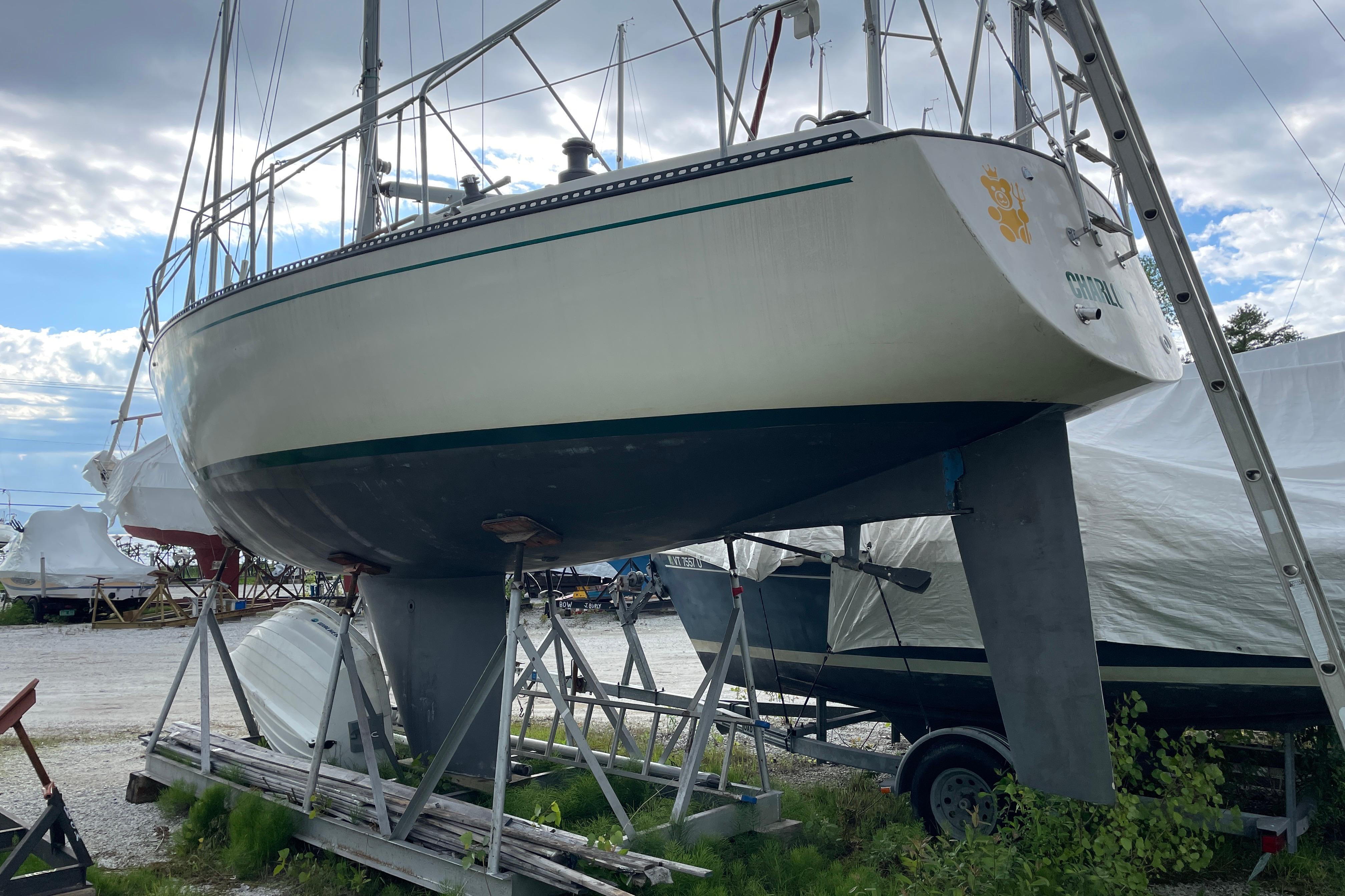 1981 Pearson 32 sailboat on stands, ready for maintenance in a boatyard.