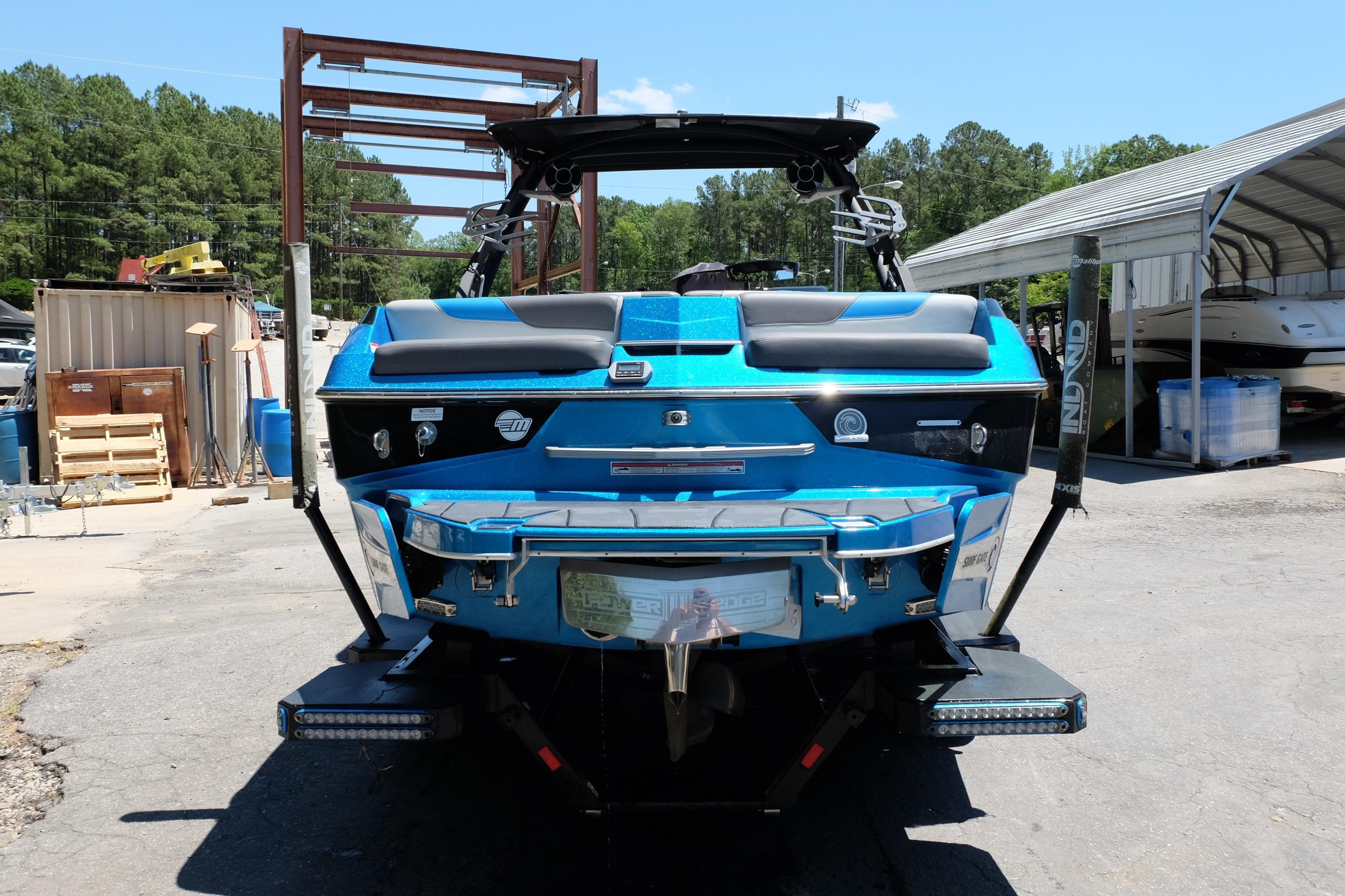 2020 Malibu Wakesetter 23 LSV boat, vibrant blue, parked outdoors on a sunny day.