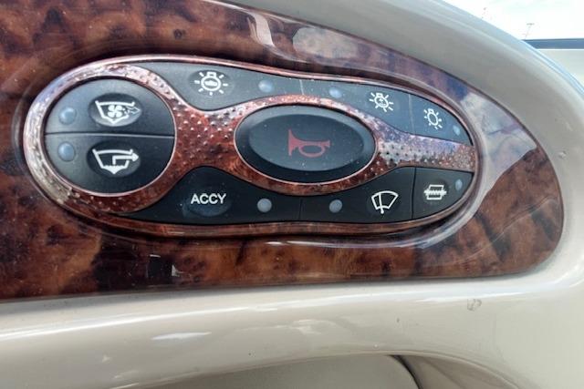 Control panel of a 2003 Sea Ray 260 Sundancer boat with various switches.