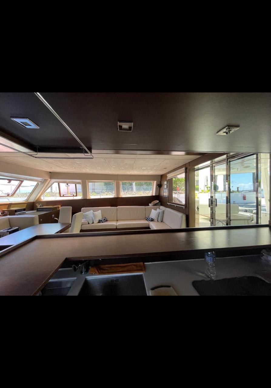 Luxurious interior of a 2009 Sunreef 62 yacht with panoramic windows and modern furnishings.