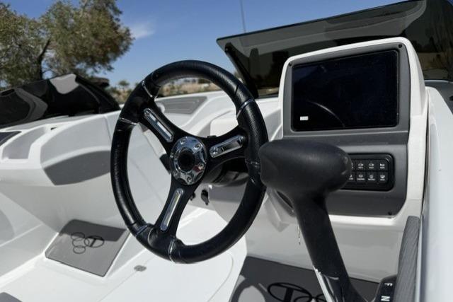 Steering wheel and dashboard of 2026 Tahoe T21 boat, featuring modern controls and sleek design.