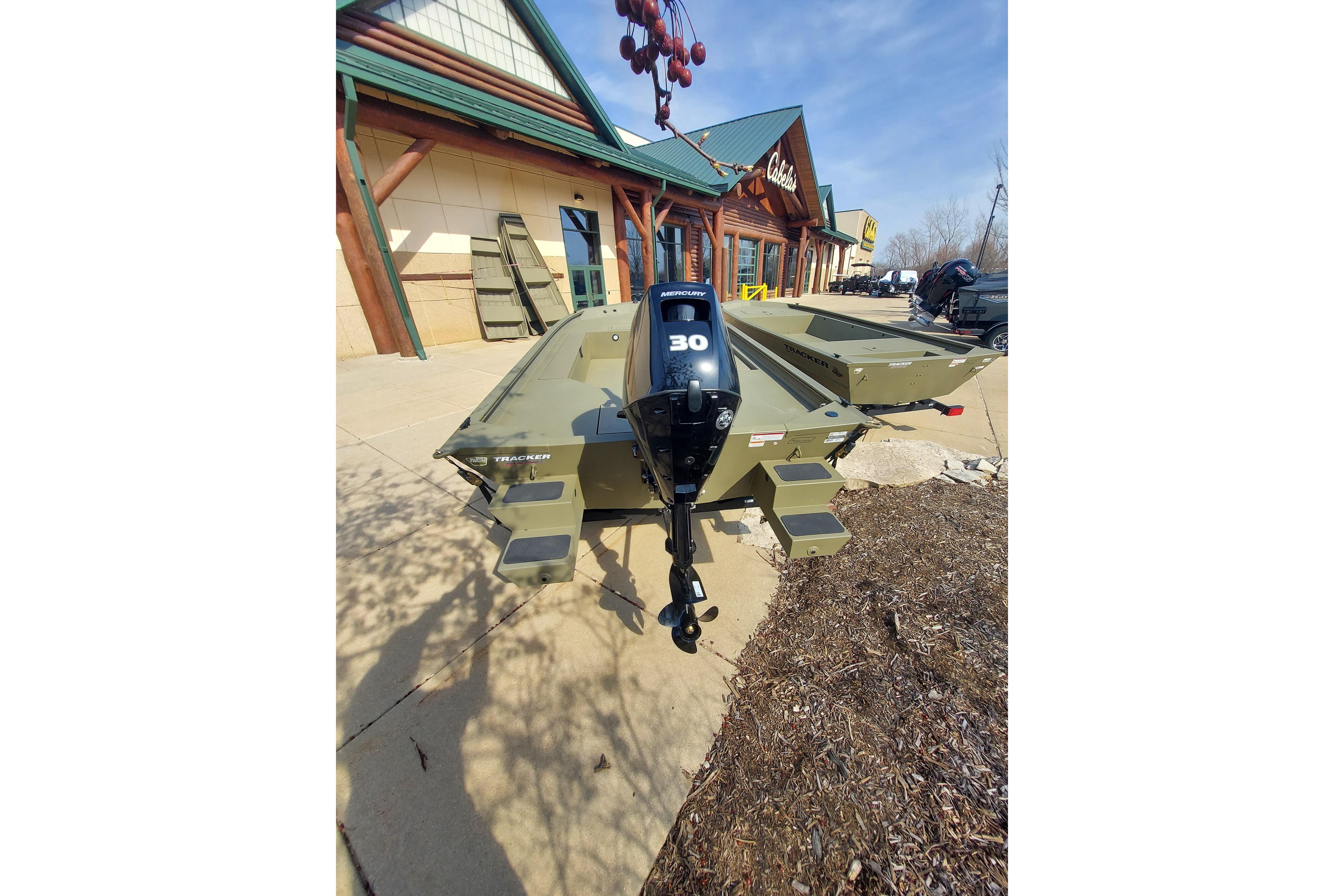 2026 Tracker Grizzly 1654 T Sportsman boat displayed outside a store.