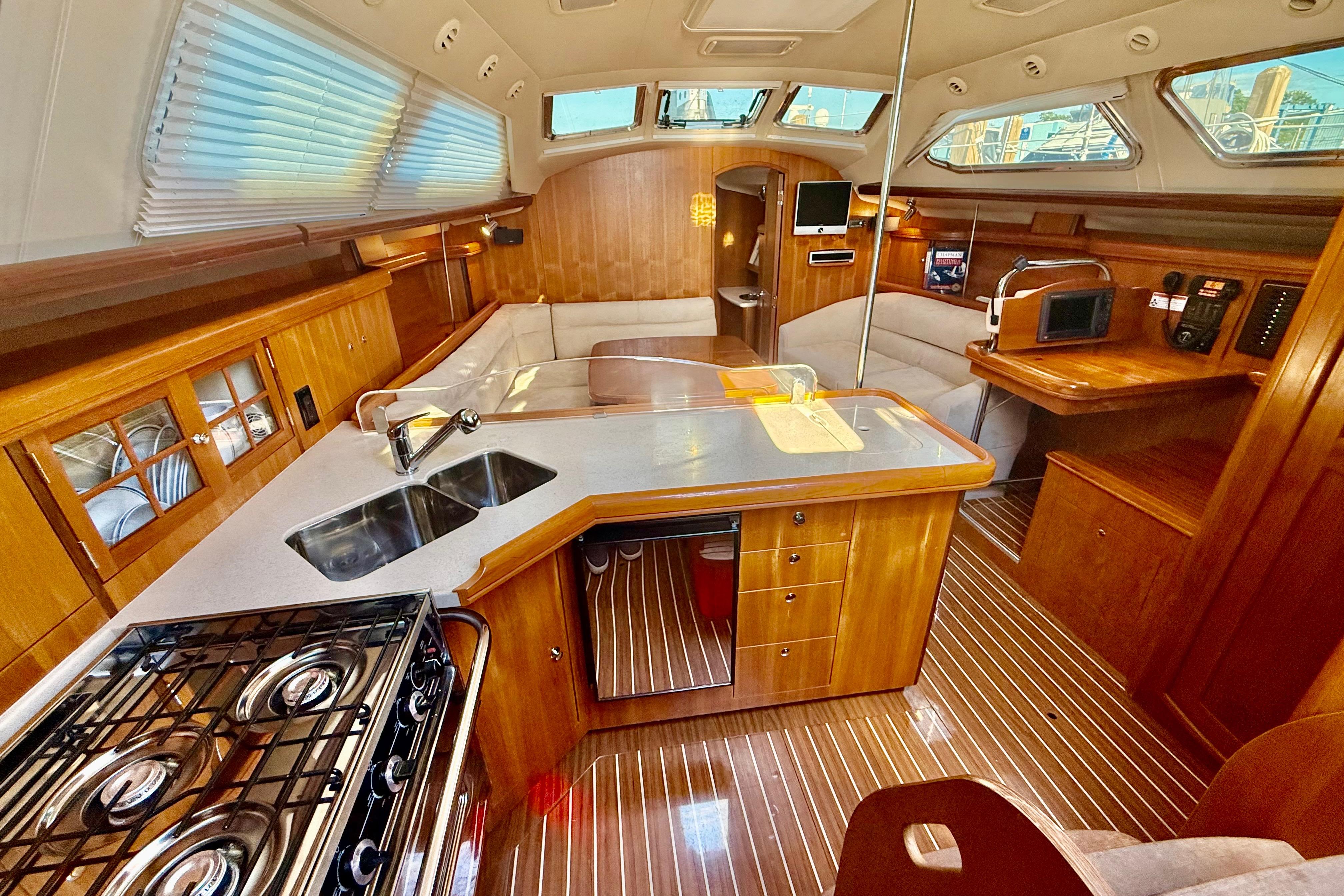 Luxurious 2007 Hunter 41 Deck Salon interior with modern kitchen and cozy seating area.