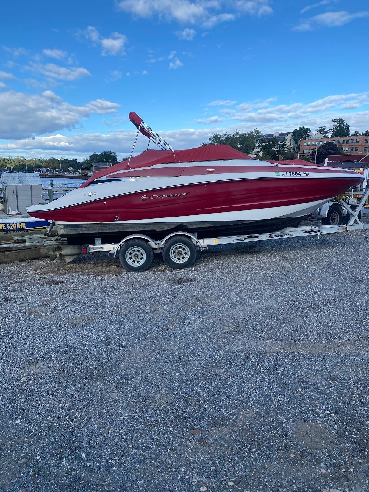 2014 Crownline Eclipse E2 boat on trailer by the shore.