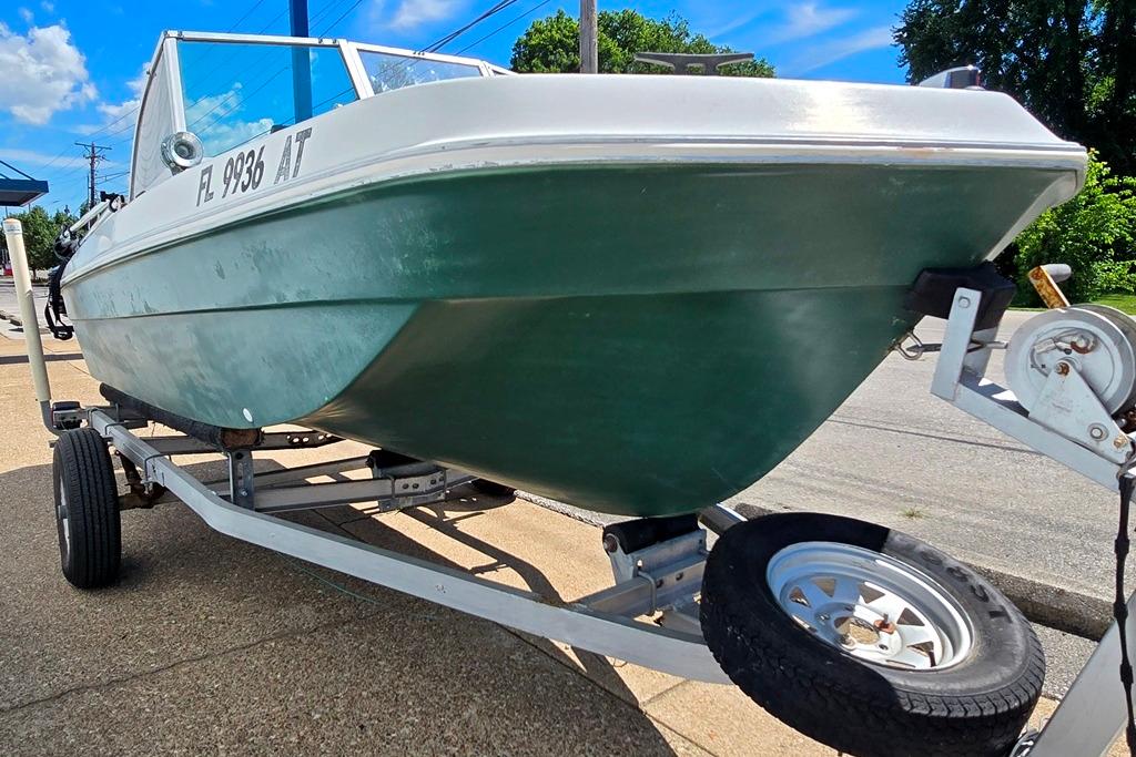 1971 Jupiter 15' Tri Hull boat on trailer, parked outdoors under blue sky.