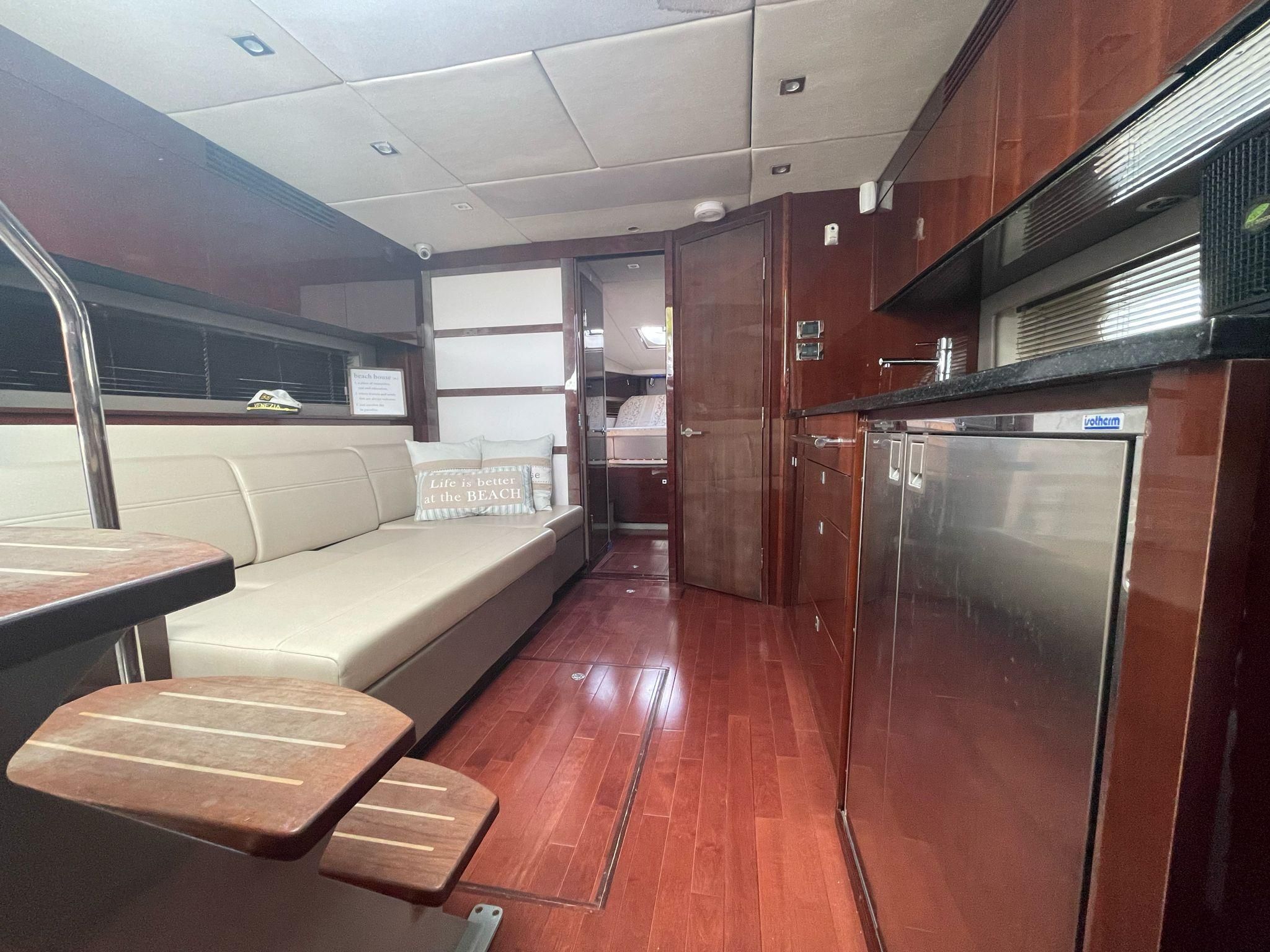 Interior of a 2010 Sea Ray 450 yacht with wooden flooring.