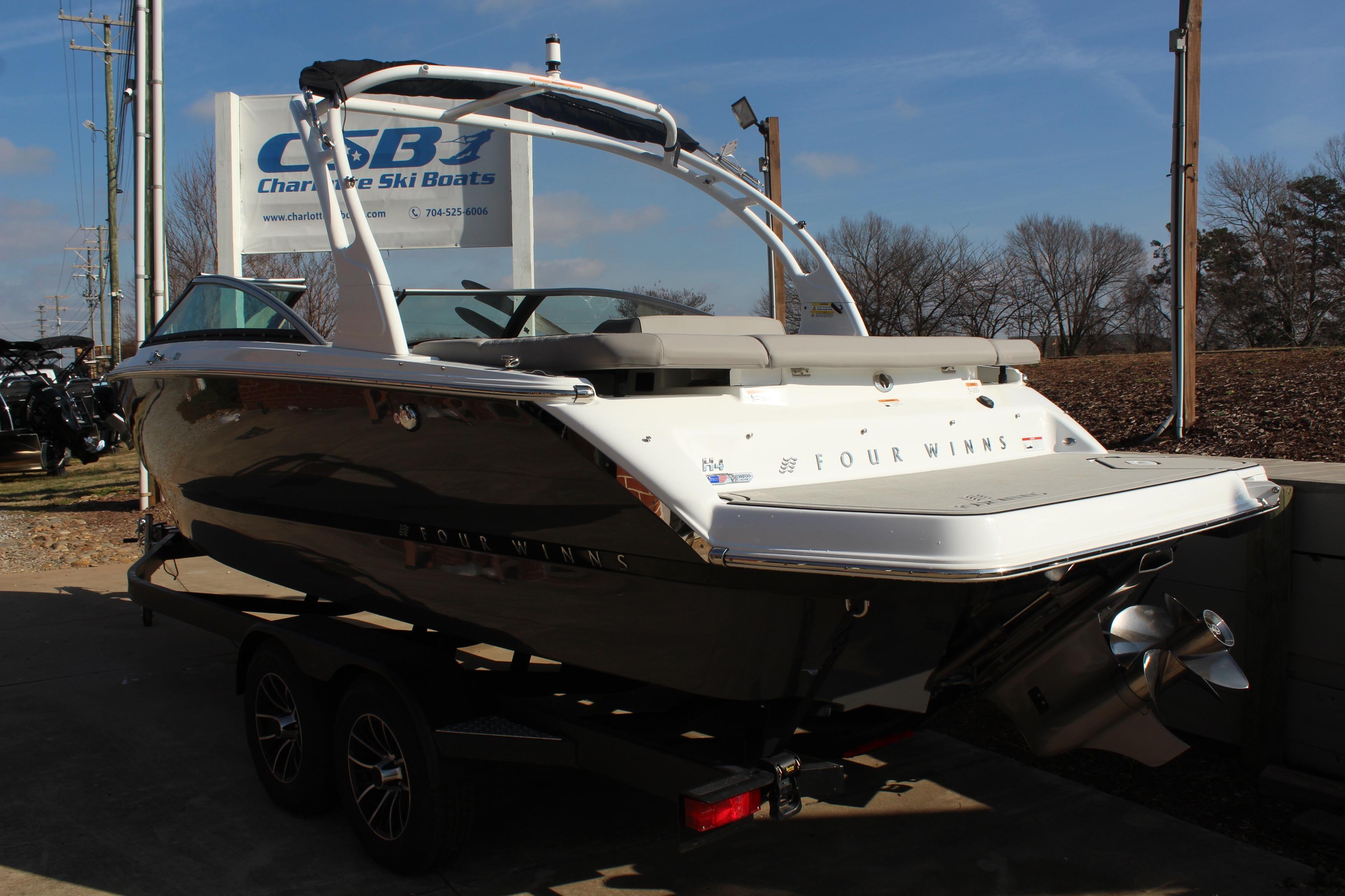 2026 Four Winns H4 boat on trailer at Charlotte Ski Boats dealership.