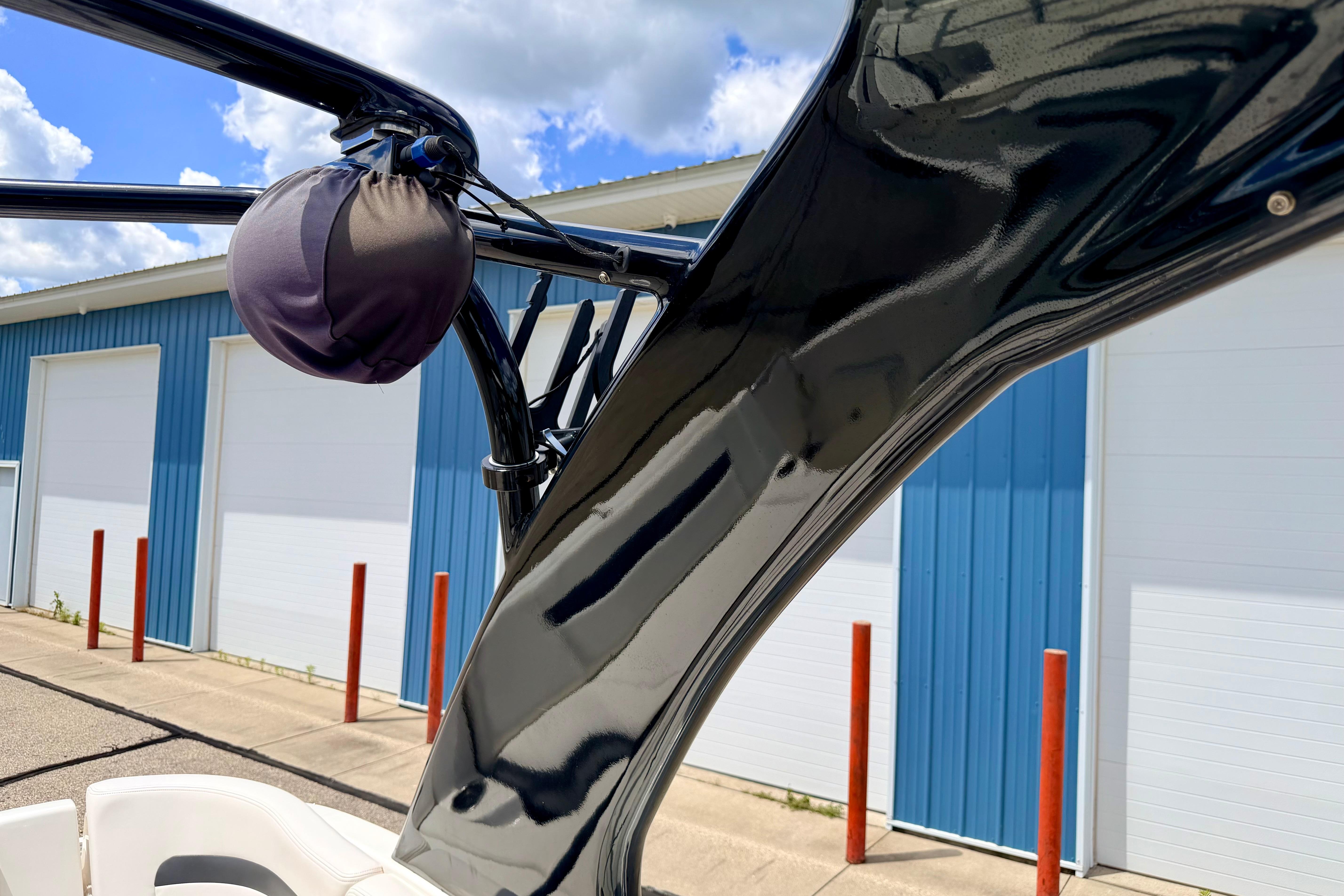 2015 Chaparral Sunesta 264 boat detail with blue storage building background.