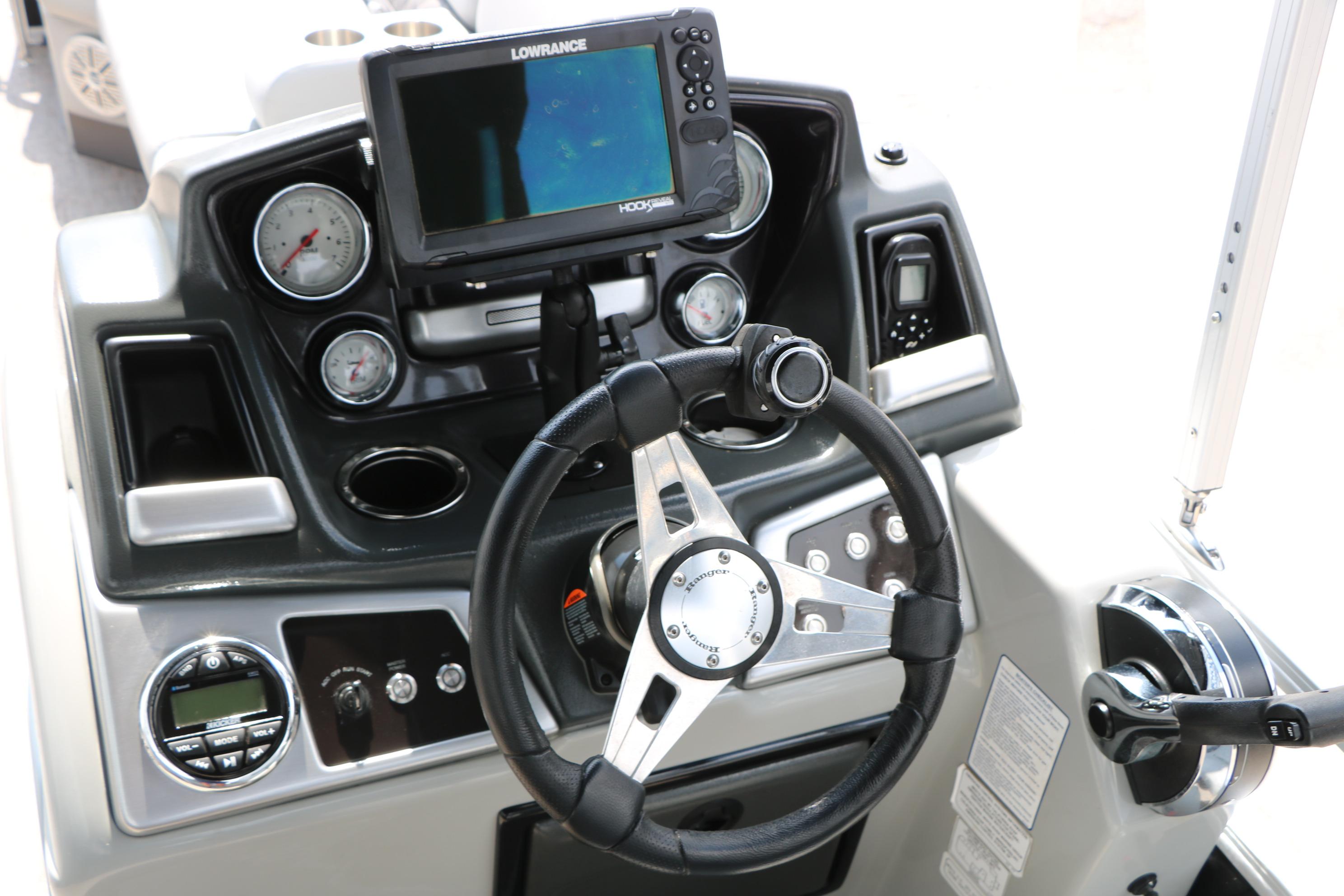 2021 Ranger 223FC boat dashboard with steering wheel, gauges, and Lowrance fishfinder.
