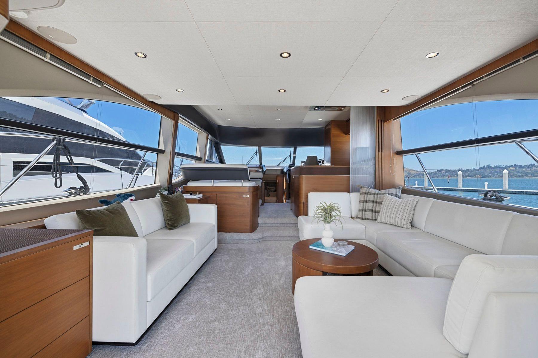 Luxurious interior of 2015 Princess 60 Flybridge Motor Yacht with elegant seating and panoramic windows.
