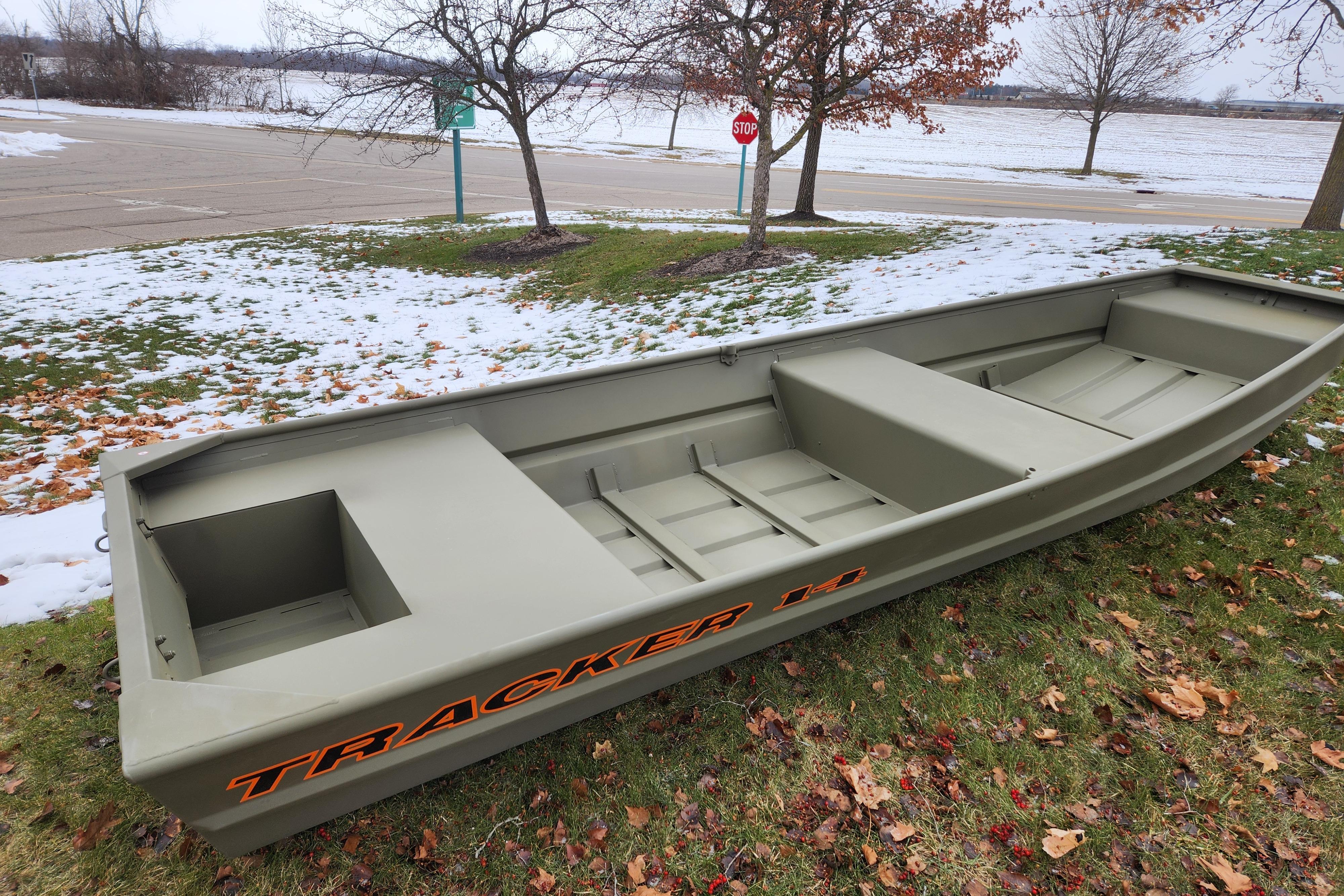 2026 Tracker Grizzly 14 Jon boat on snowy grass, showcasing its sturdy design.