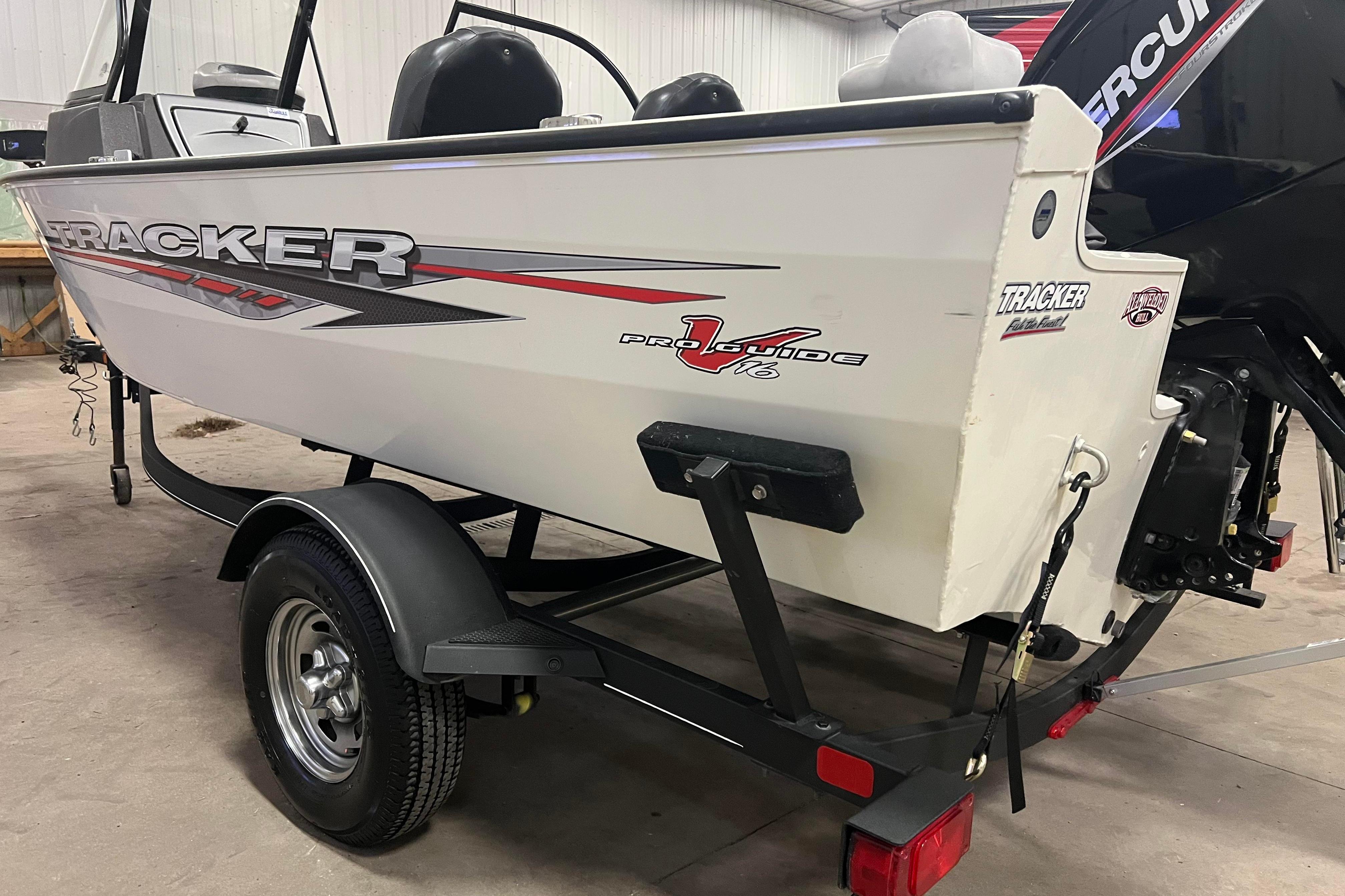 2022 Tracker Pro Guide V-16 WT boat on trailer in garage setting.