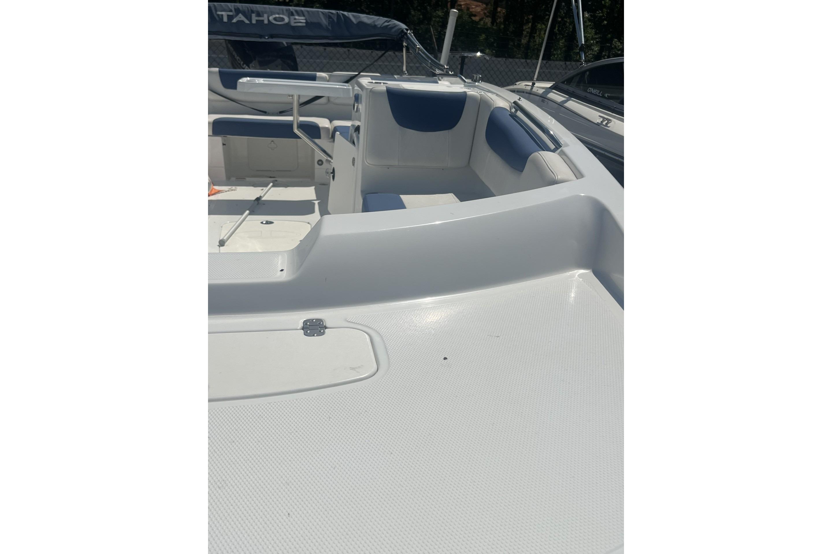 2017 Tahoe 2150 boat interior with white and blue seating, spacious deck.