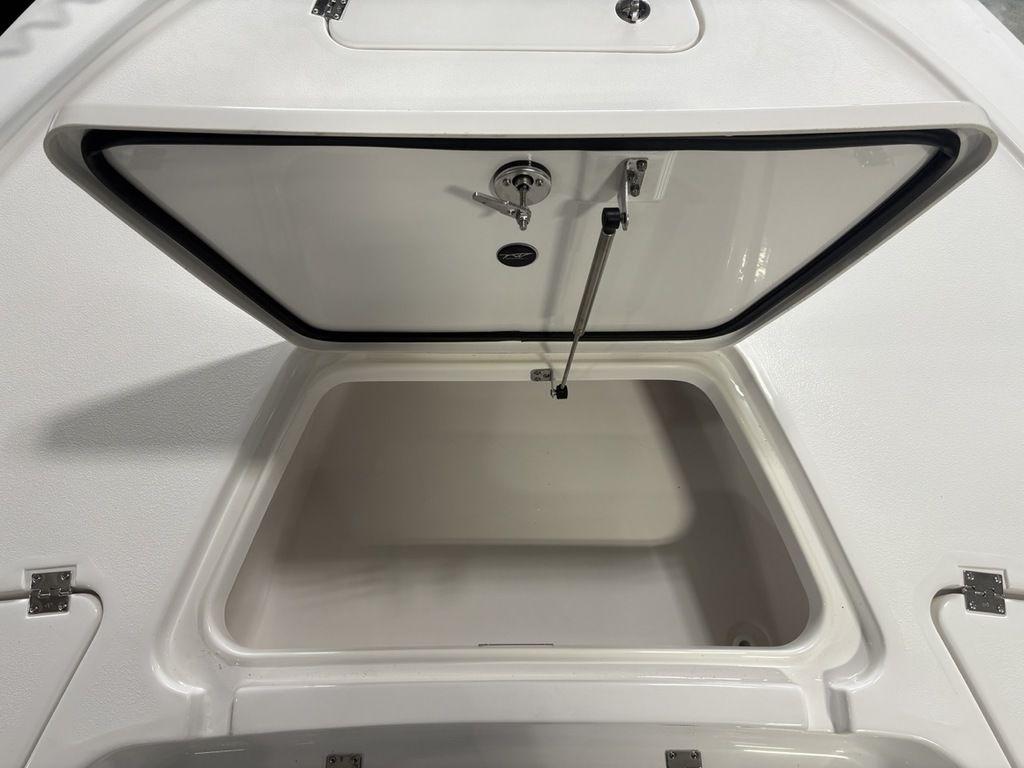 Open storage compartment on 2026 Tidewater 2110 BM boat, showcasing interior space.