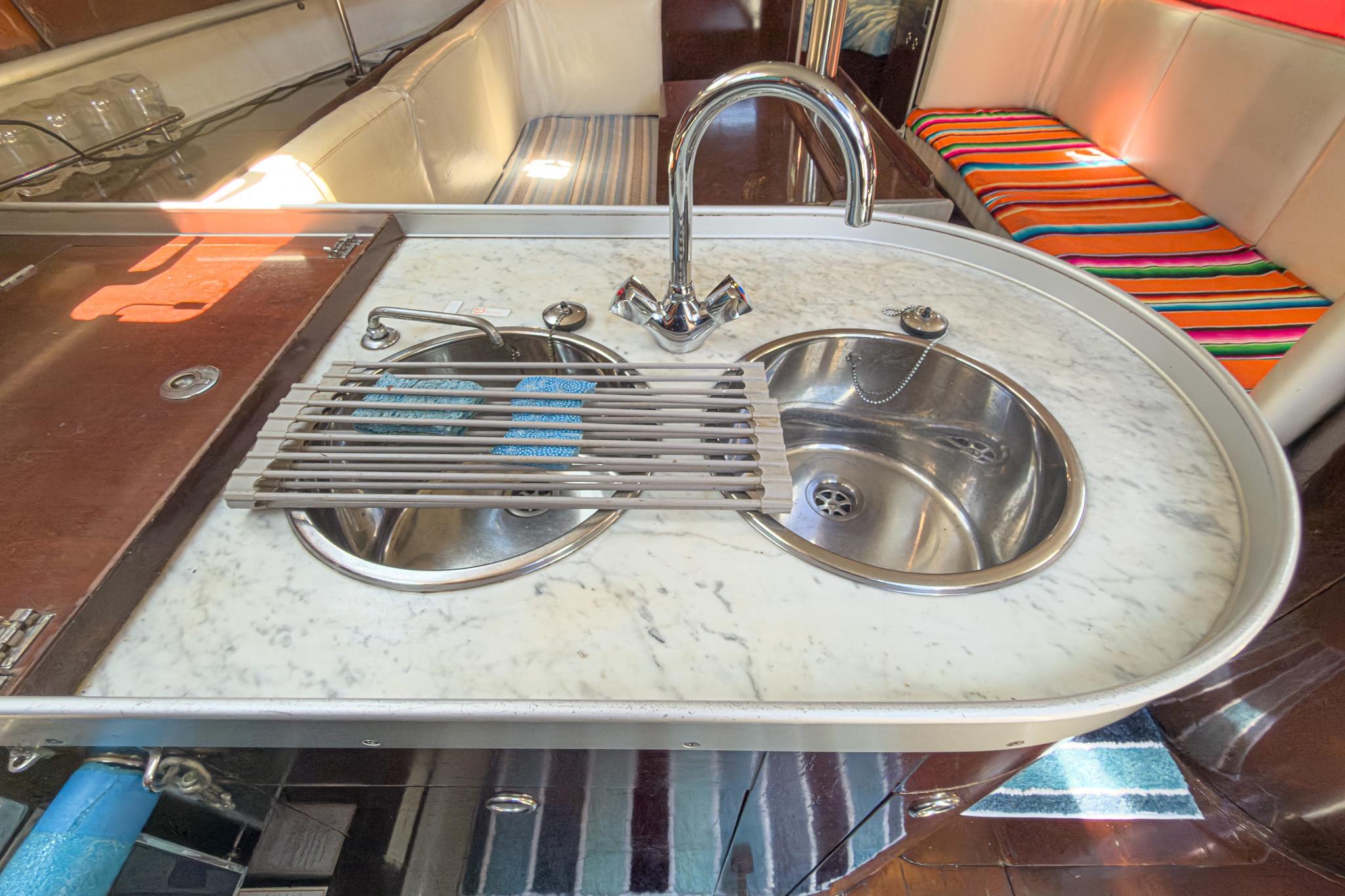 Marble countertop with dual sinks in 1993 Beneteau First 38 s5 yacht interior.