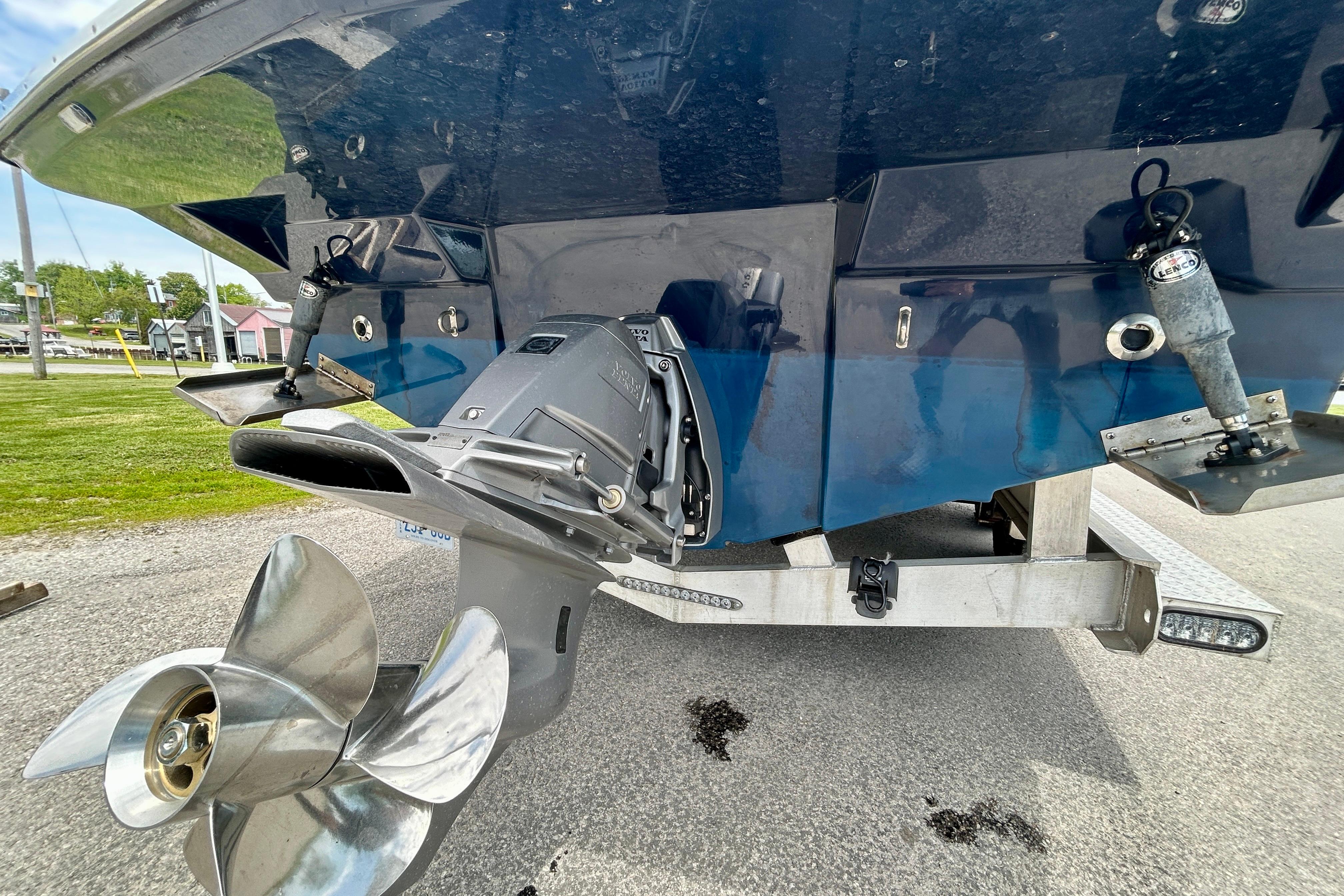 2016 Cutwater C-24 boat stern with propeller and trim tabs on trailer.