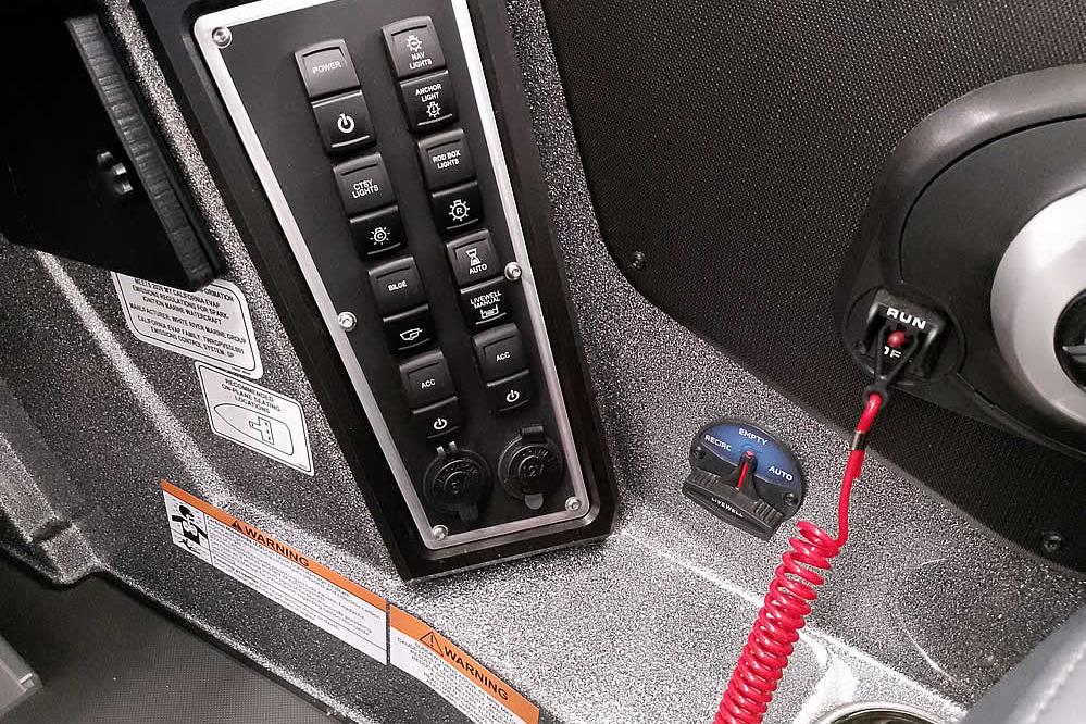 Control panel of 2026 Ranger Z519R Cup-Equipped boat with switches and warning labels.