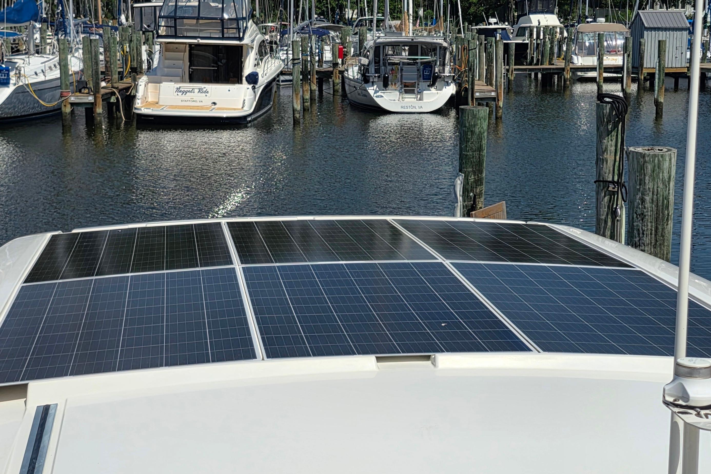 Solar panels on 2023 Greenline 40 yacht docked at marina.