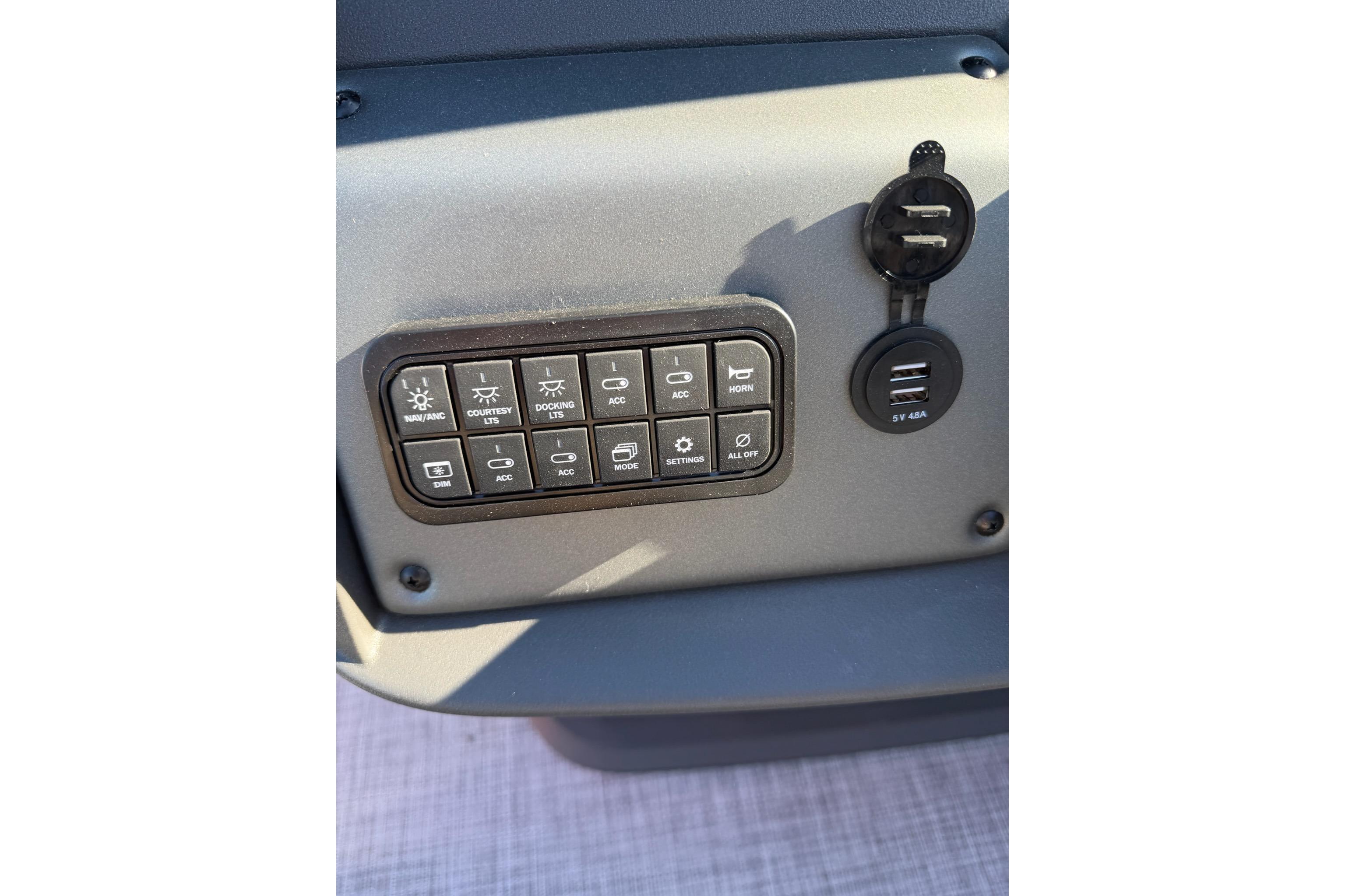 Control panel of 2026 Sun Tracker Party Barge 18 DLX with USB ports and switches.