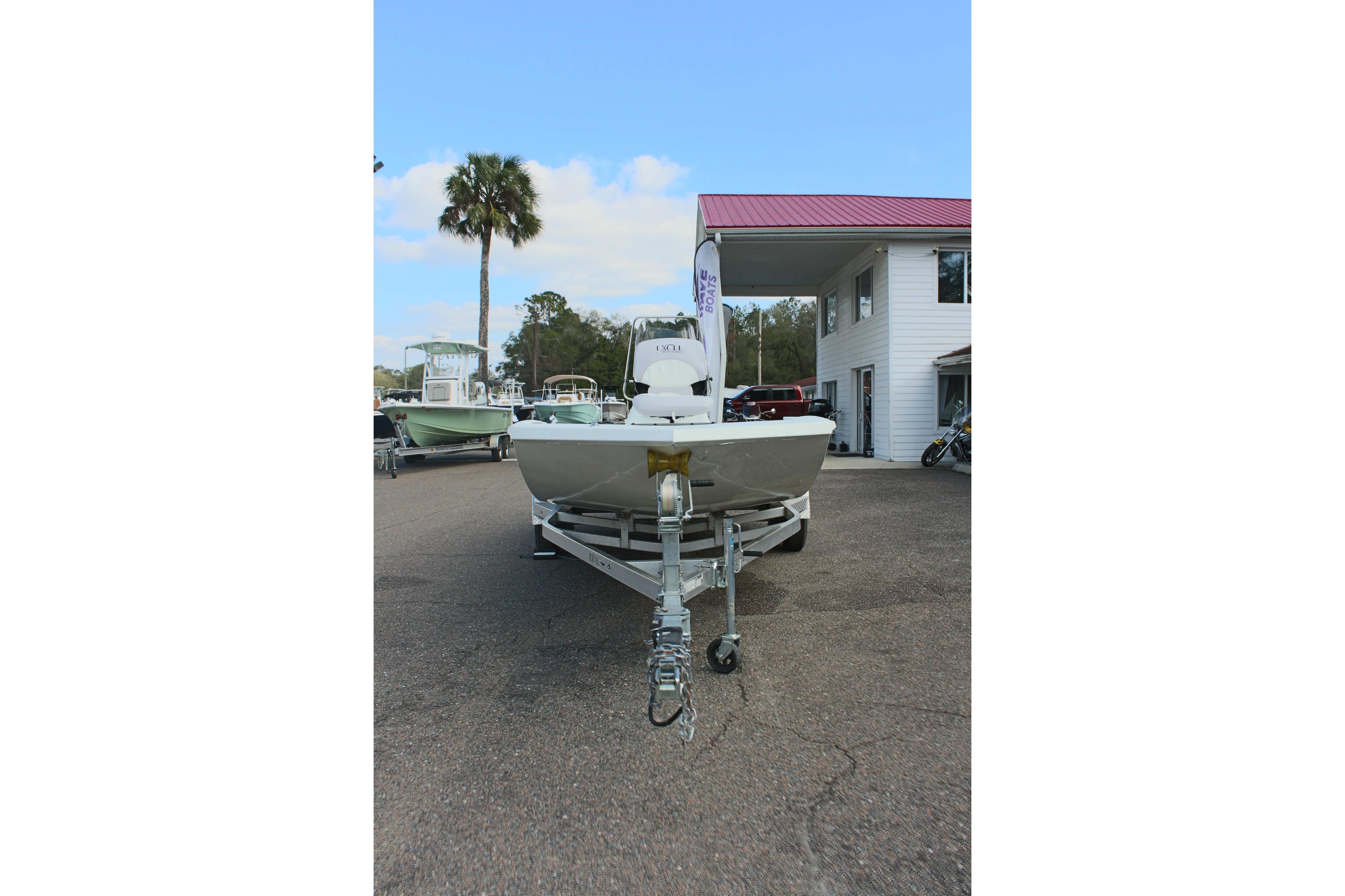 2025 Excel 2172 Stalker CC boat on trailer, parked outside dealership.