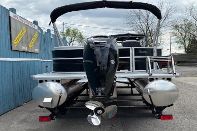 2026 Sun Tracker Party Barge 20 DLX pontoon boat, rear view with motor and canopy.
