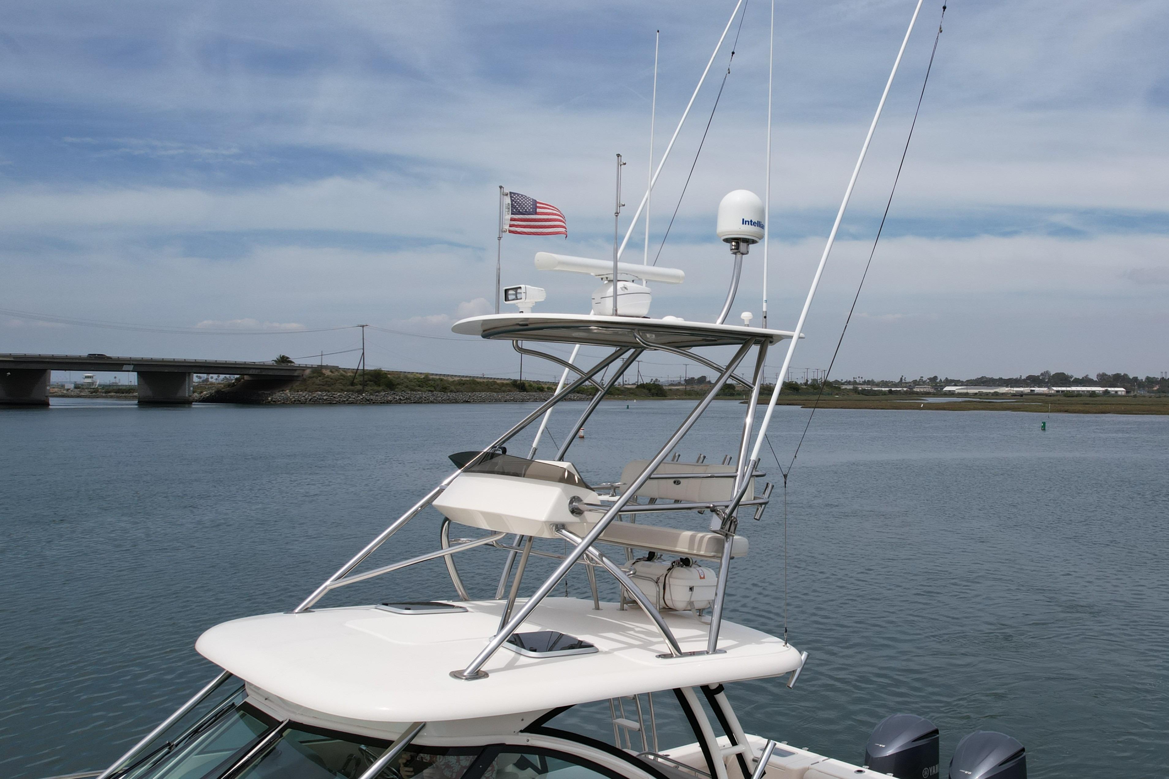 2012 Pursuit OS 345 Offshore boat with radar and American flag on calm water.