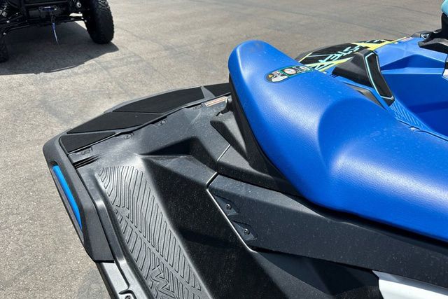 Close-up of a blue jet ski with a black deck and graphic details.