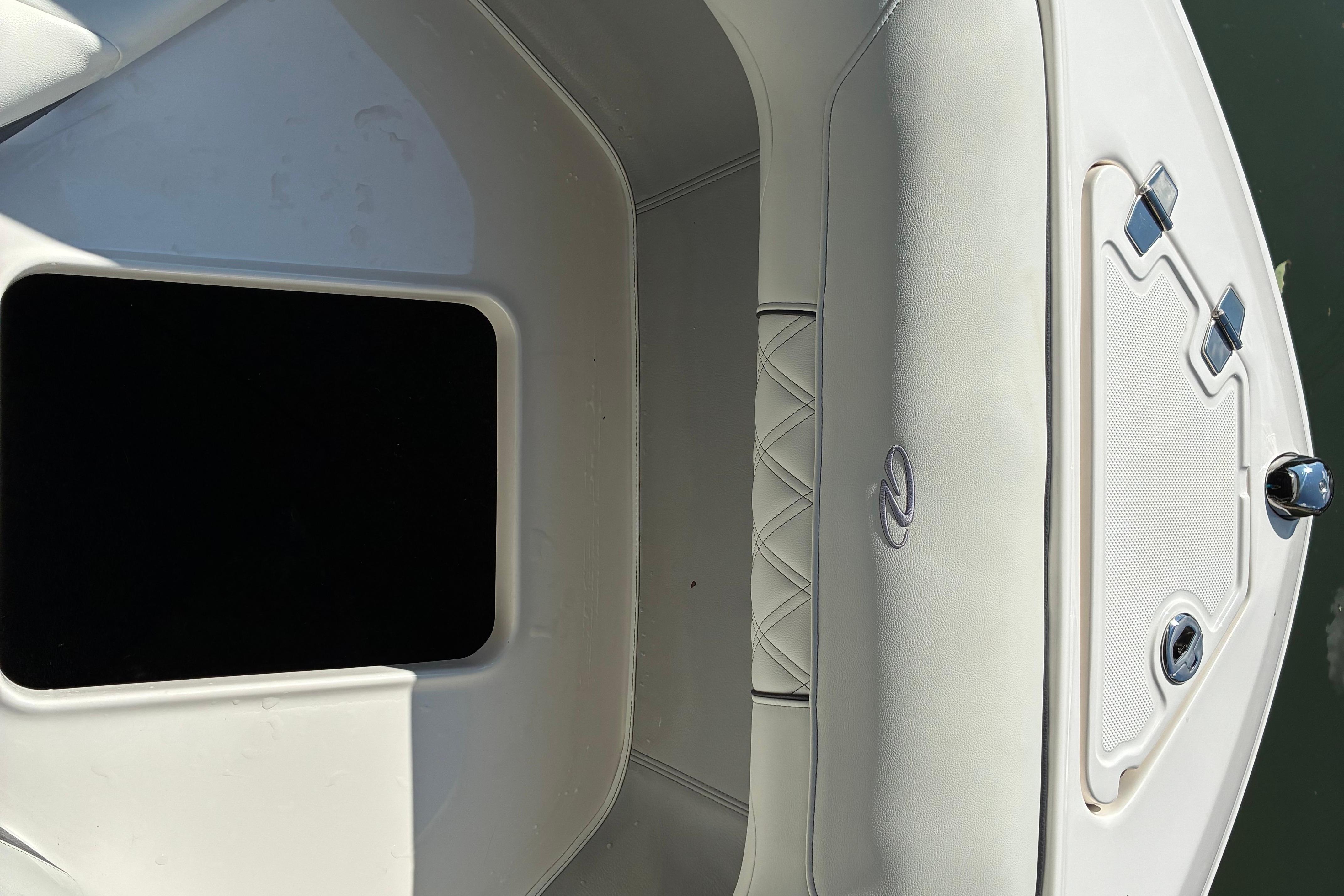 2025 Regal LS2 boat interior with white cushioned seating and storage compartment.